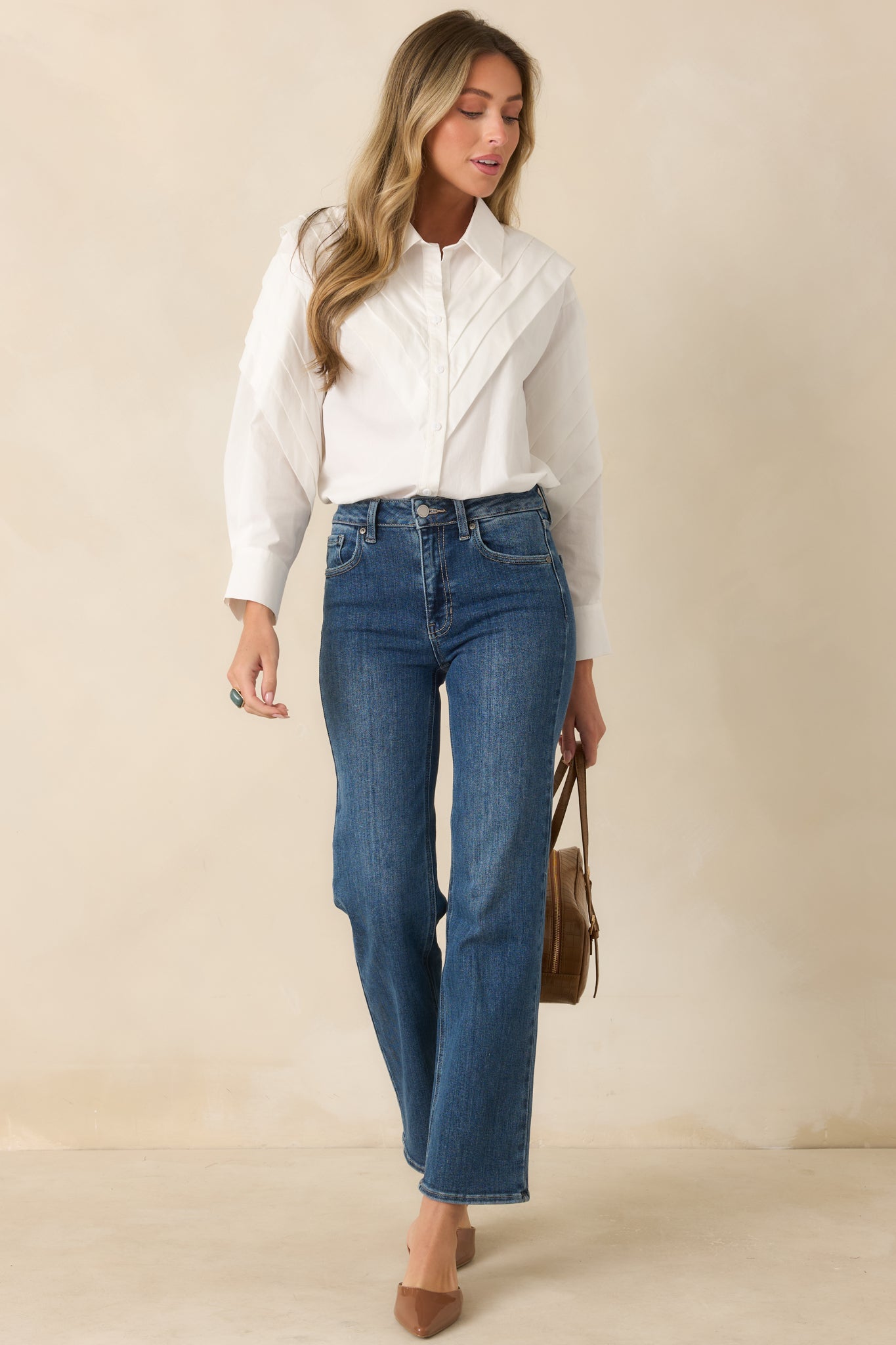 Structured white blouse featuring a collared neckline, woven cotton fabric, and dimensional shoulder accents.