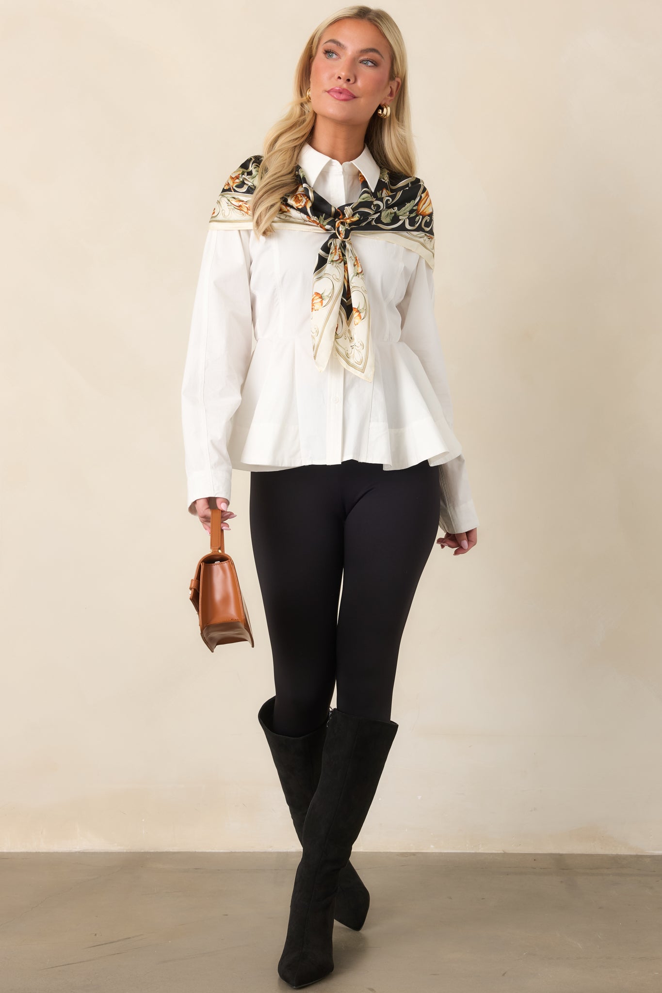 Structured white peplum top featuring a crisp button front, shaping seams, and a flared hem.