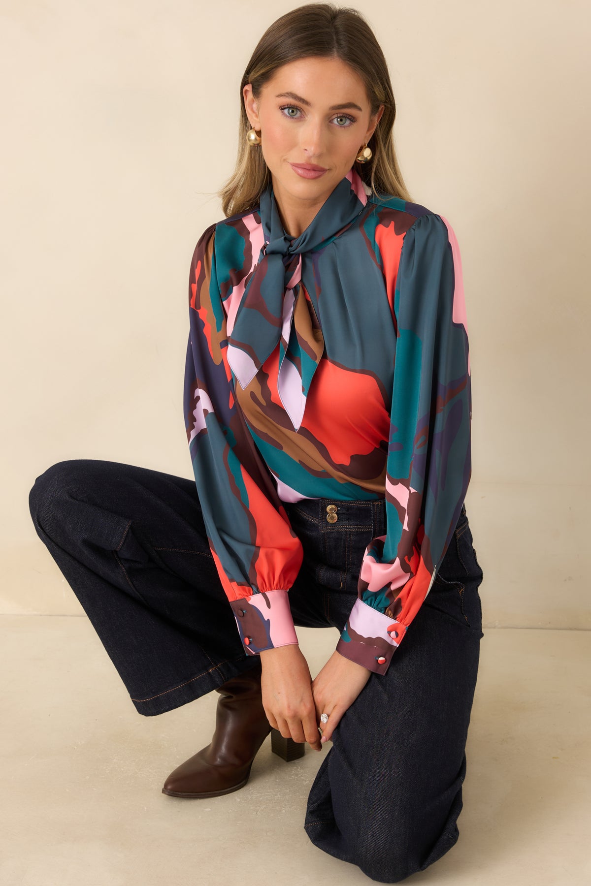 Multicolor study print blouse with puff shoulders and long sleeves finished with button cuffs.