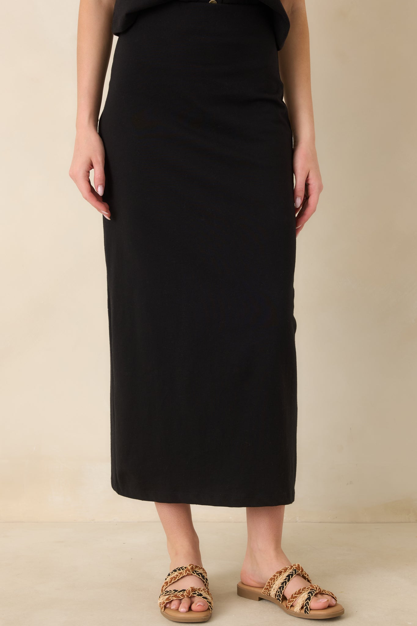 Subtle back slit detail providing movement in a fitted, polished skirt.