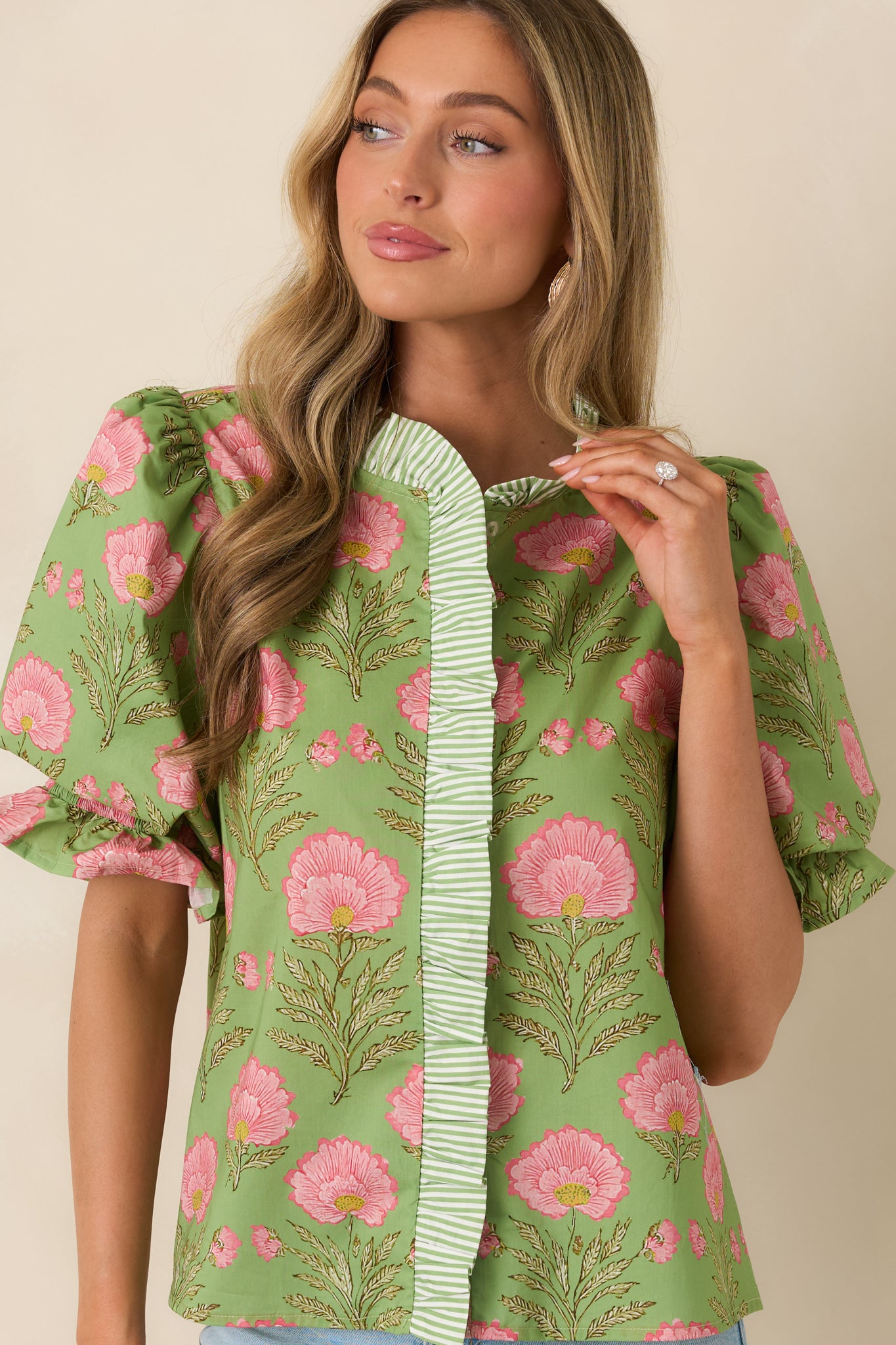 Subtle shoulder gathering creating soft volume at sleeve cap.