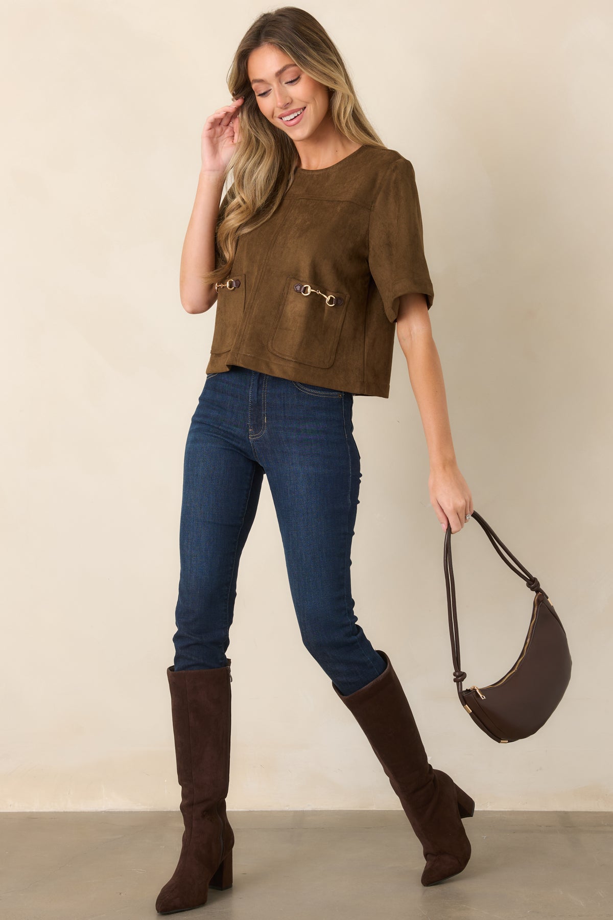 Soft suede-like top featuring a round neckline, short sleeves, oversized front patch pockets, and a relaxed boxy silhouette.