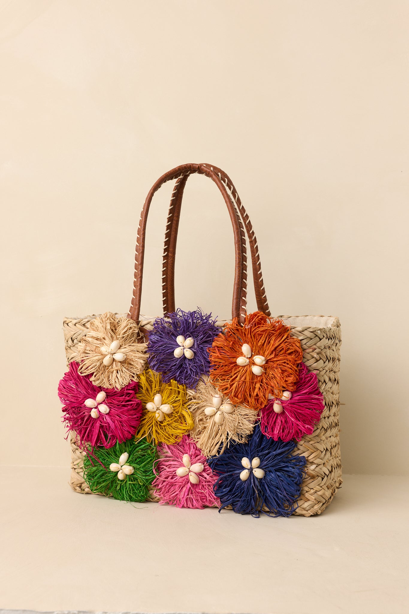 Summer tote handbag showcasing a polished silhouette, smooth handles, vibrant colors, and roomy interior.