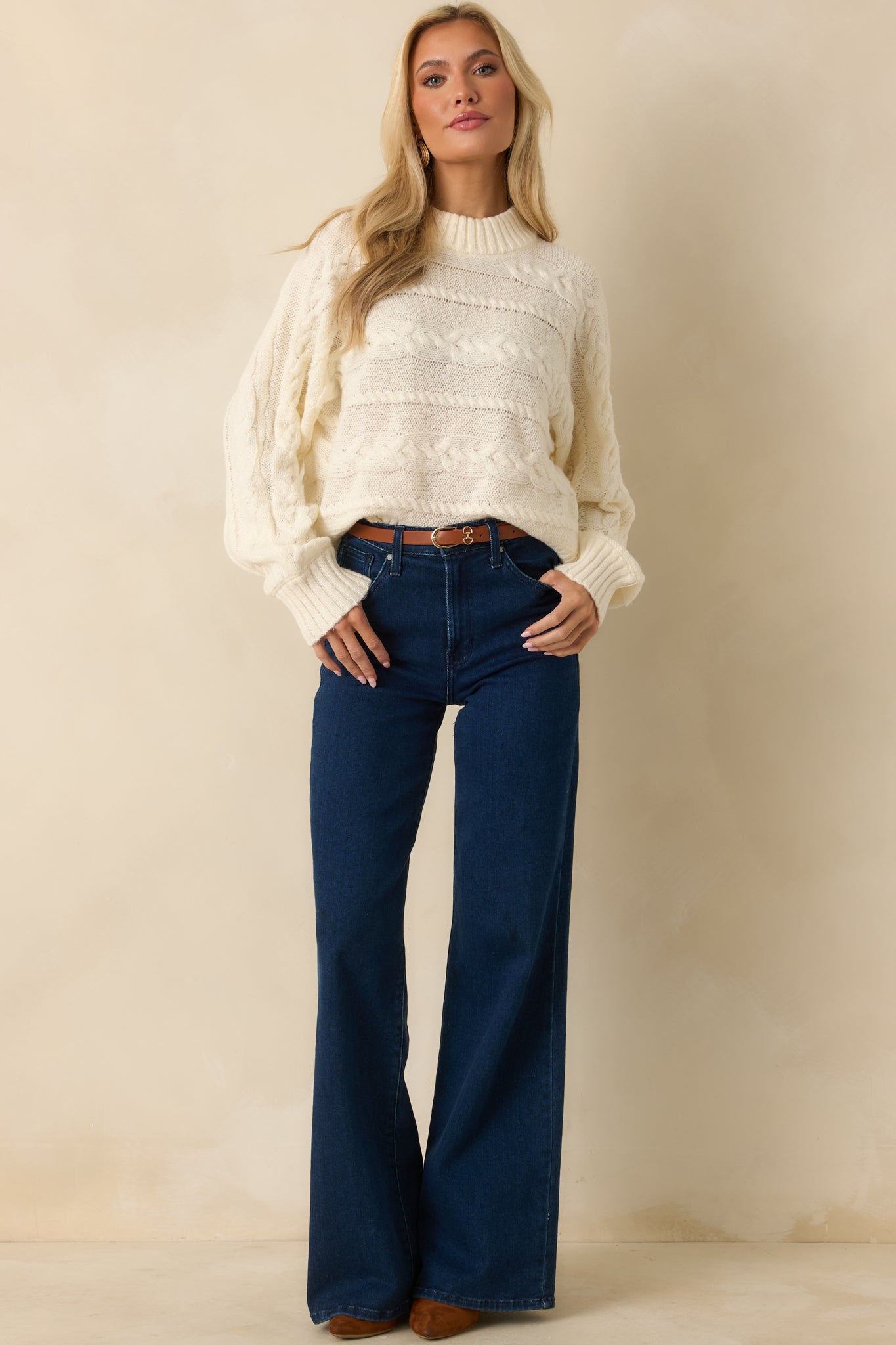 Sweater featuring cozy texture and detailed cable design throughout the front.