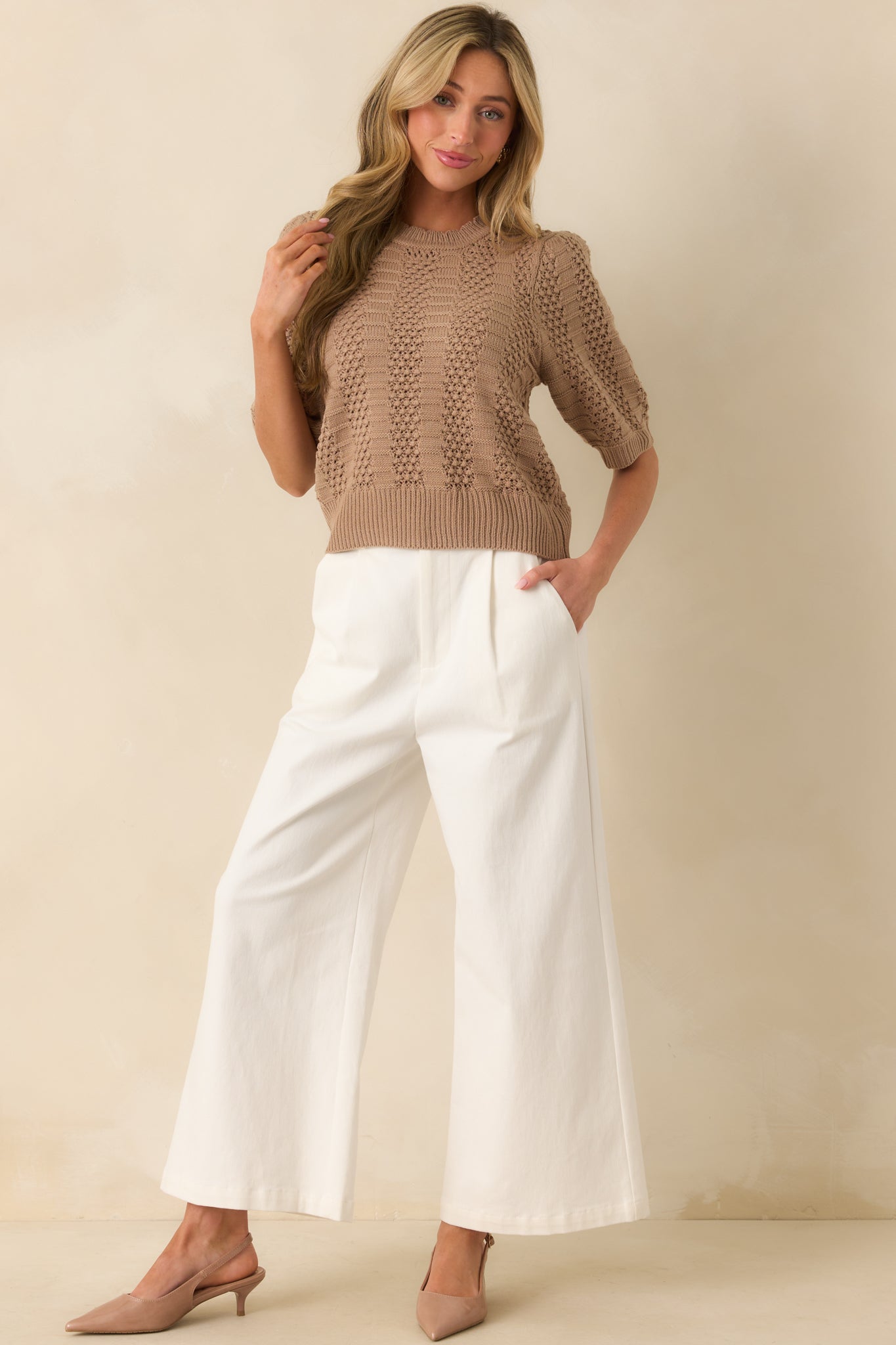 Sweater top front facing, emphasizing the vertical panel design with open crochet-knit sections.