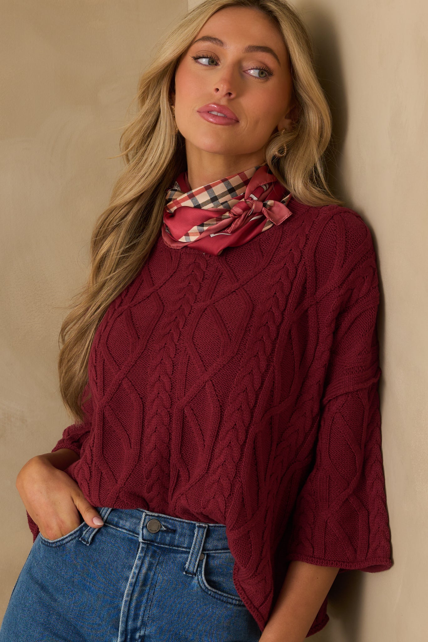 Close crop of the sweater’s midsection showing the relaxed fit and rolled hem finish.