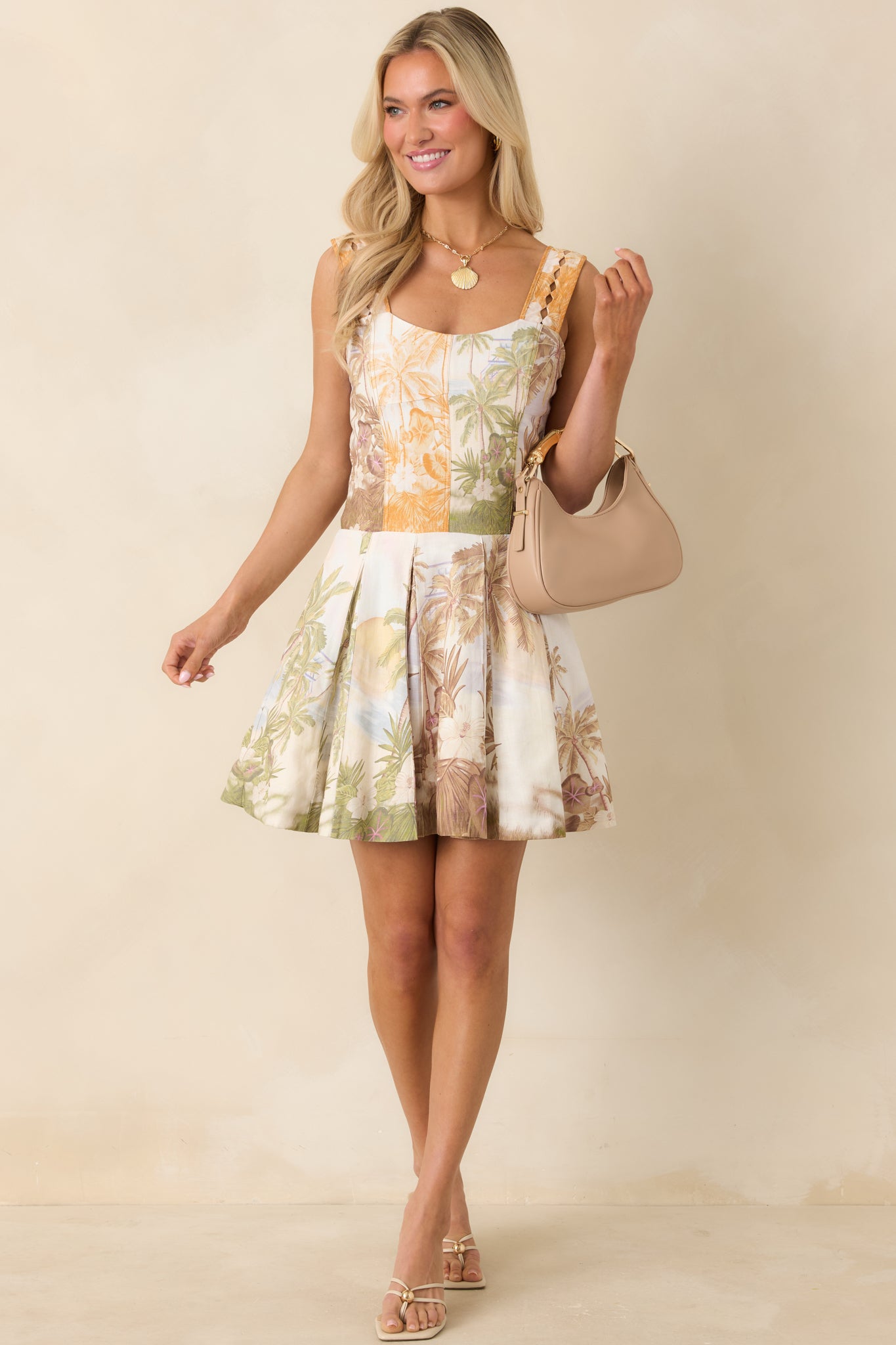 Sweetheart neckline mini dress with tailored front and soft pleated hem.