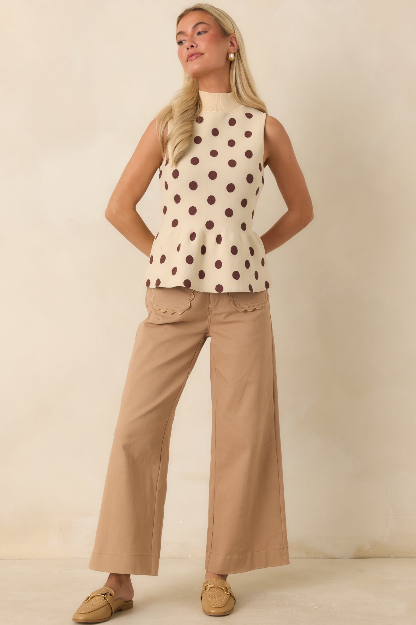 Tailored camel trousers showcasing a clean silhouette, feminine scalloped pockets, and versatile design for work or weekends.