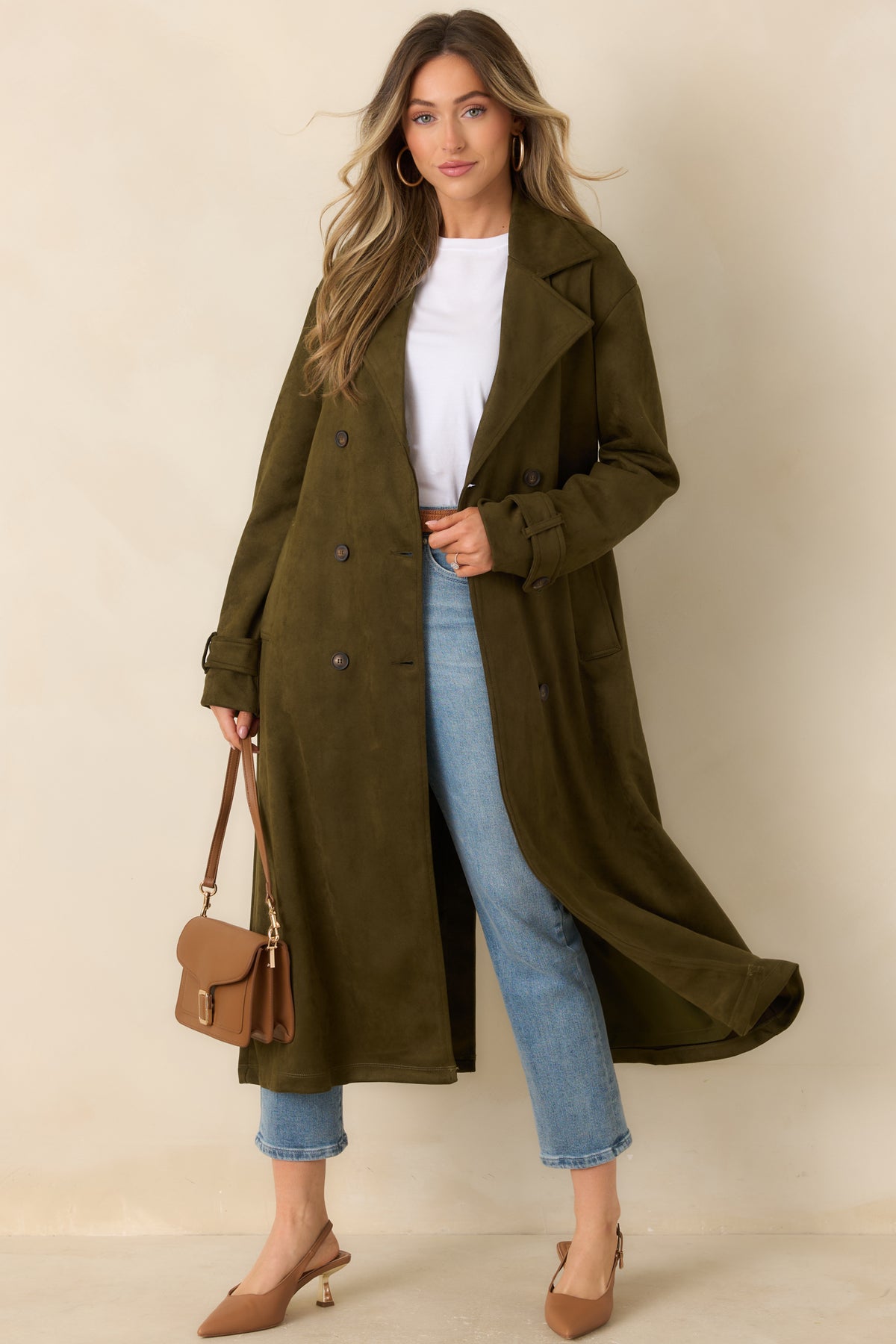 Tailored coat featuring a matching belt, long sleeves, and a classic double-breasted front.
