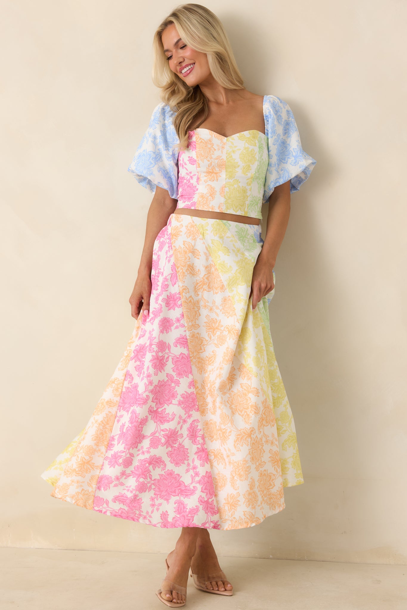 Tailored cotton linen-blend top with sweetheart neckline, puff sleeves, and vibrant multi-color floral design.