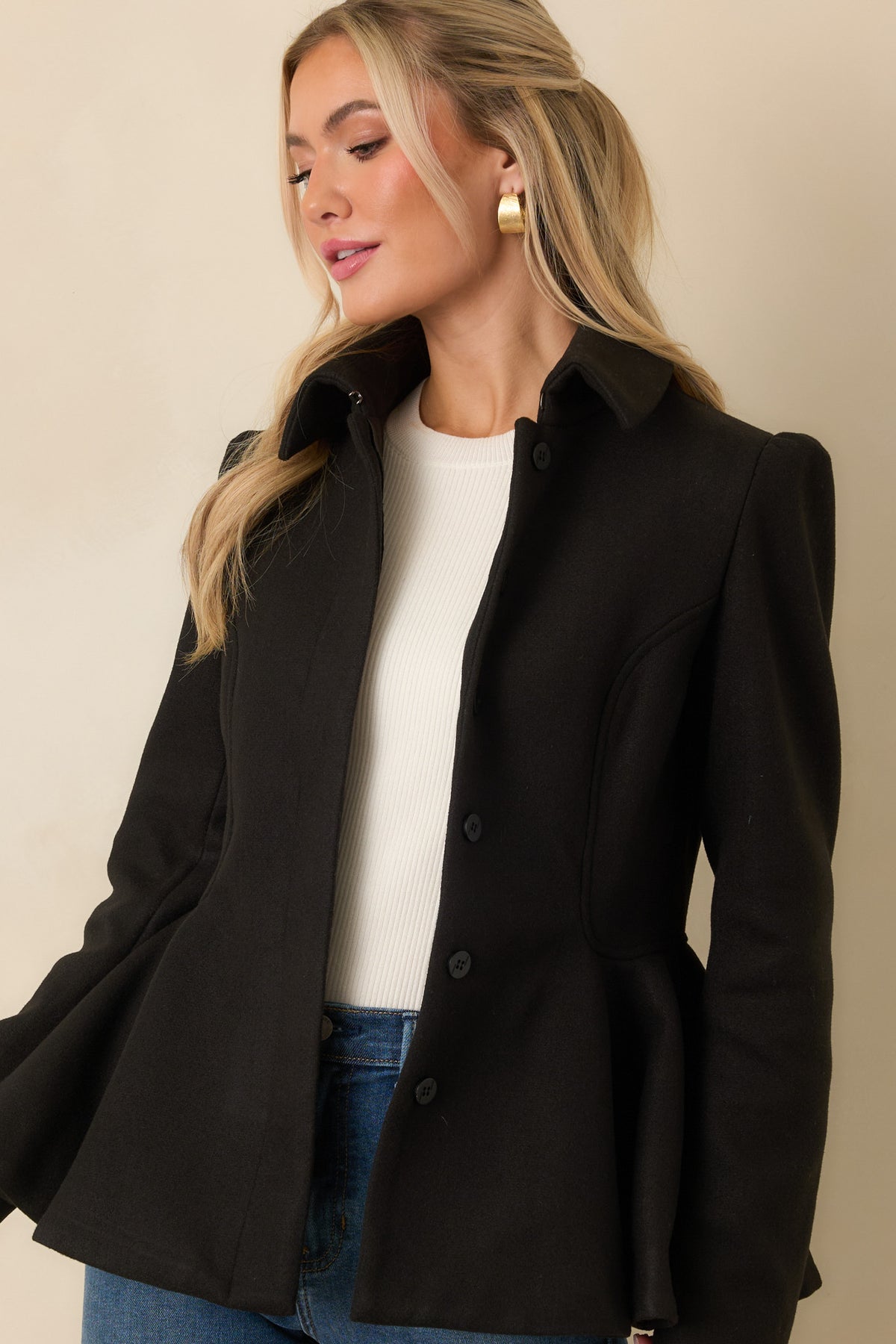 Tailored felt jacket showcasing the concealed button front and flared peplum shape.