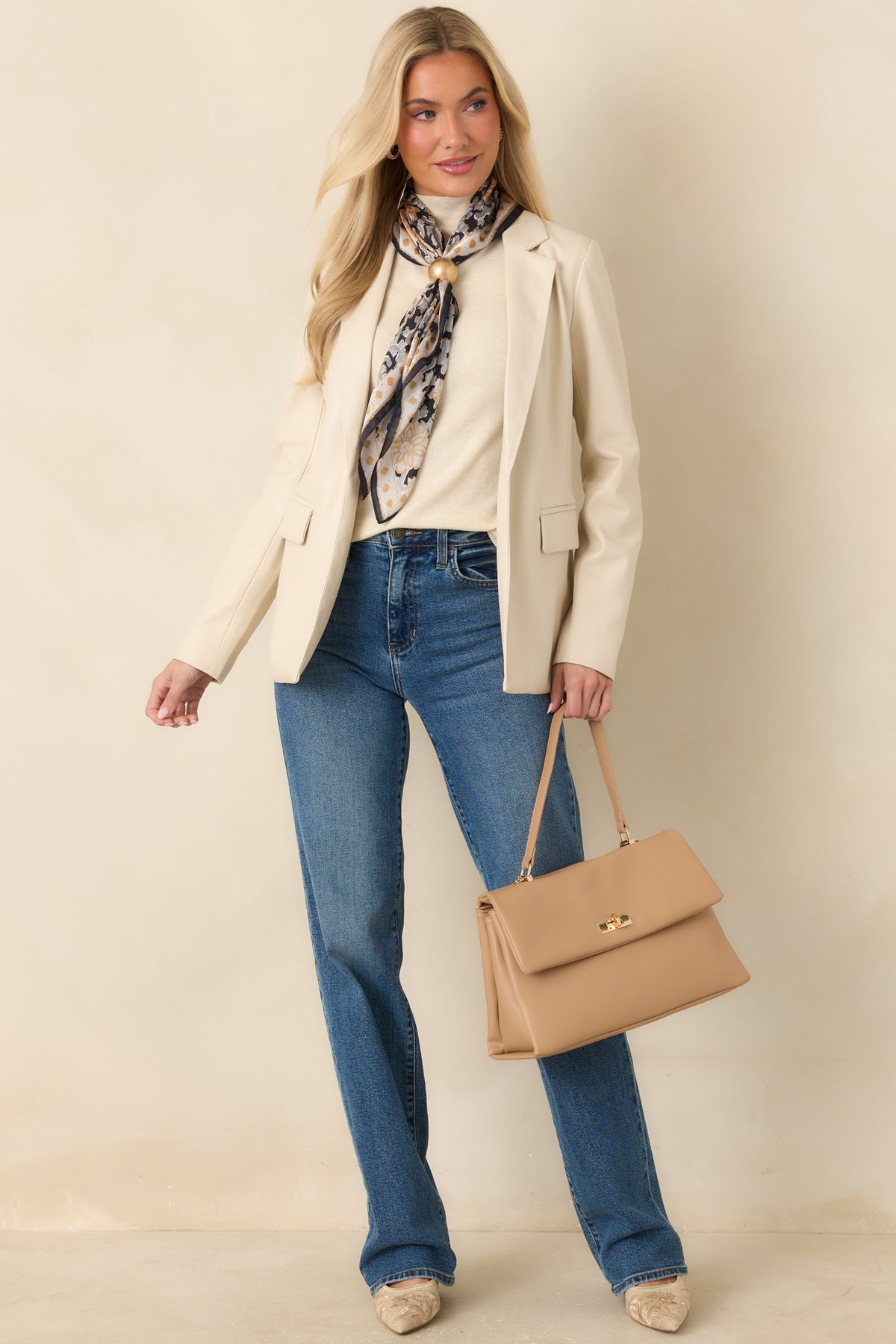 Tailored ivory blazer featuring curved waist seams and a smooth faux leather finish.