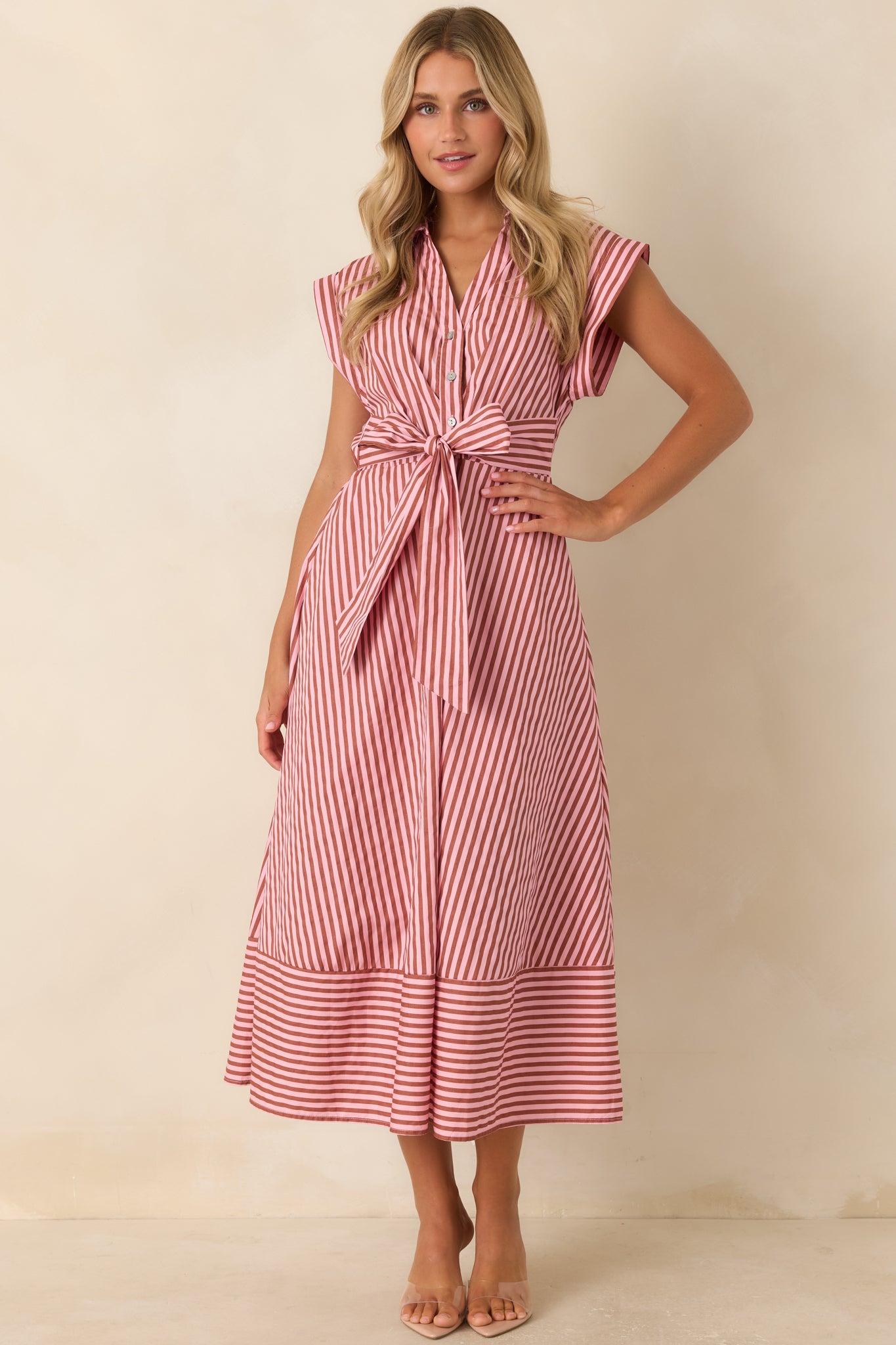 Tailored striped midi dress showcasing a collared neckline, partial button placket, statement waist bow, and comfortable silhouette.