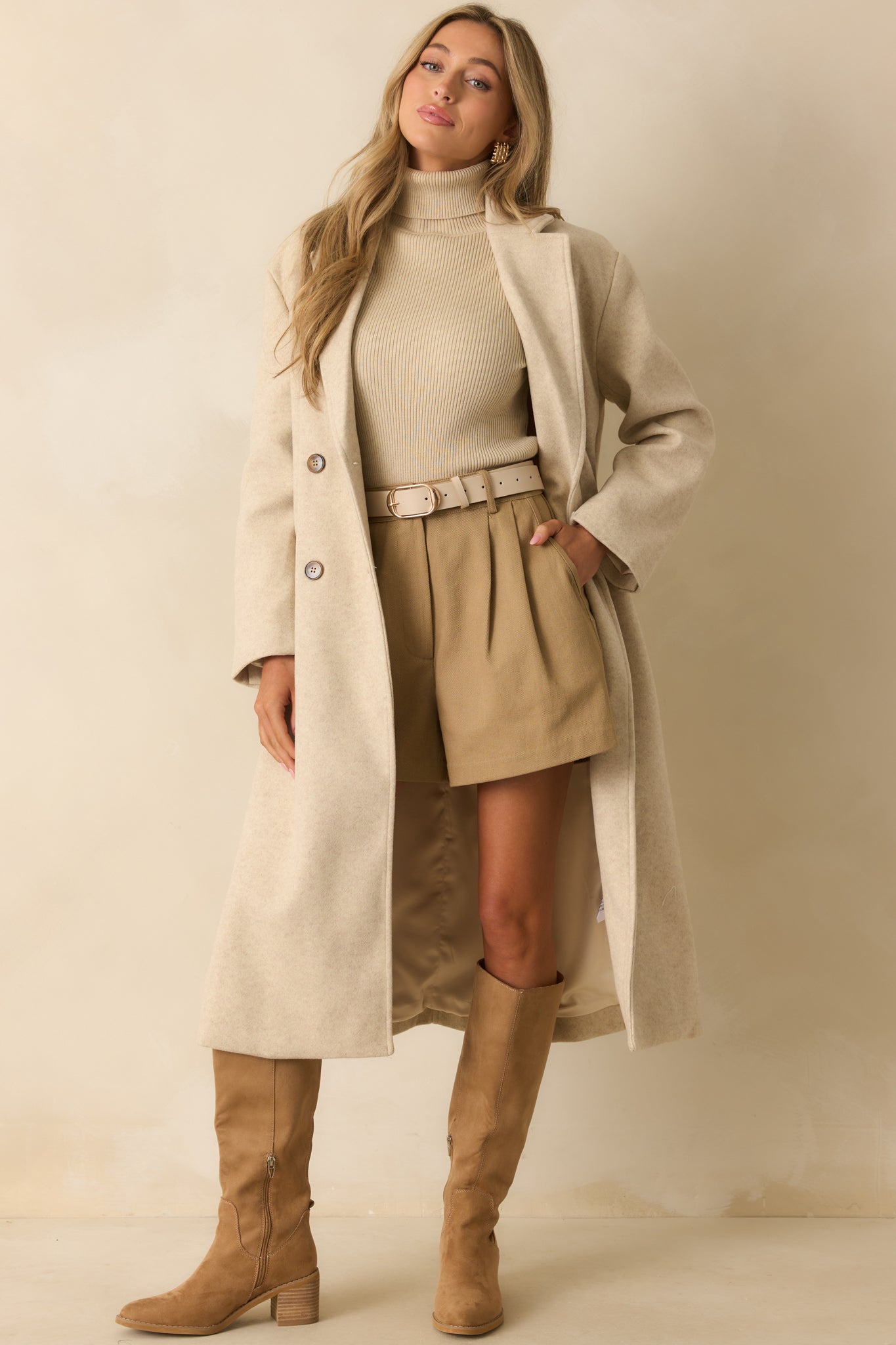 Tailored tan shorts with back patch pockets and smooth rayon fabric.