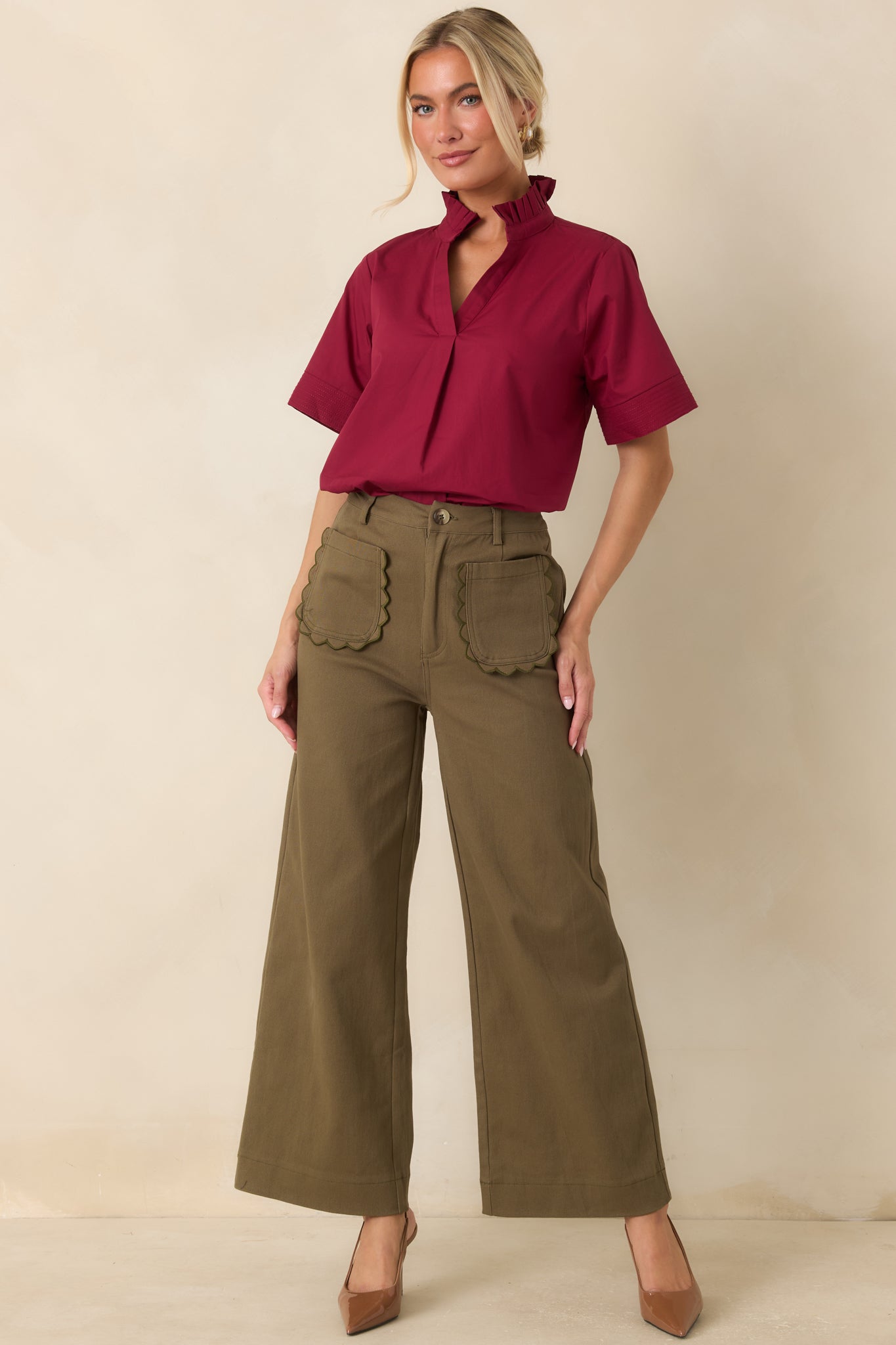 Tailored woven pants designed with a flattering high-rise fit, front button closure, and effortlessly polished wide legs.