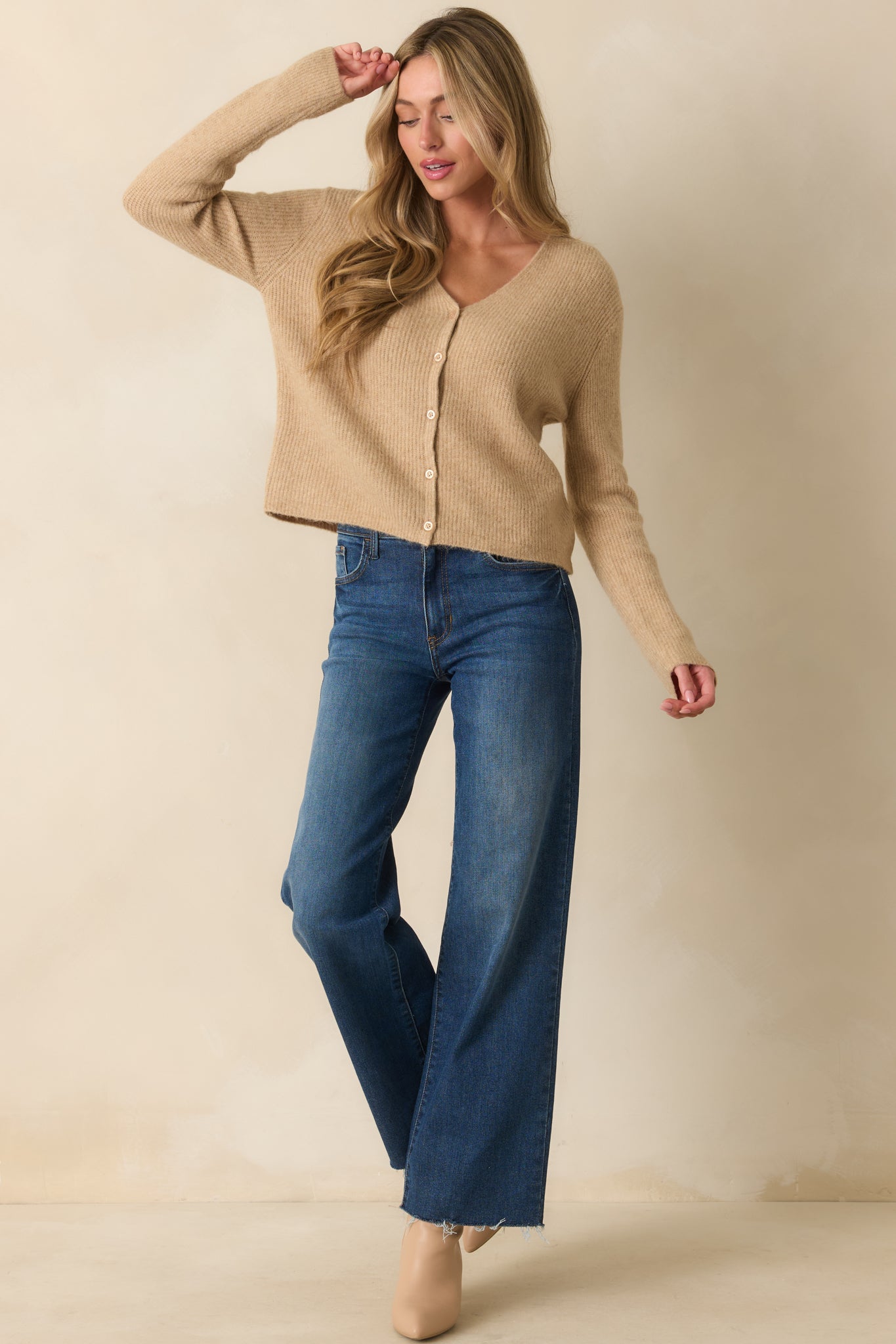 Front-facing image of tan cardigan showing long sleeves and relaxed fit.