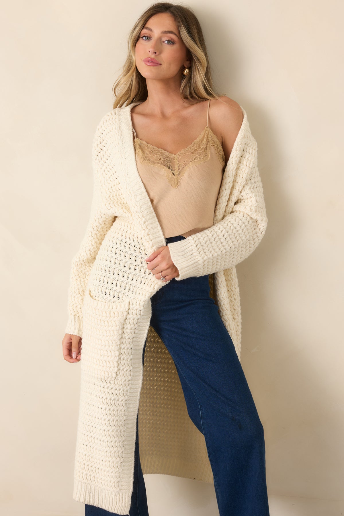 Crinkled tan top with a softly draped silhouette and tonal lace detailing along the neckline.