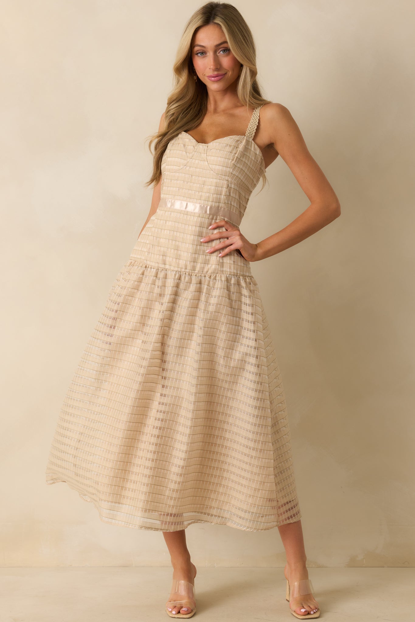 Tan dress displayed front facing, showcasing the intricate embroidery and fitted bodice.