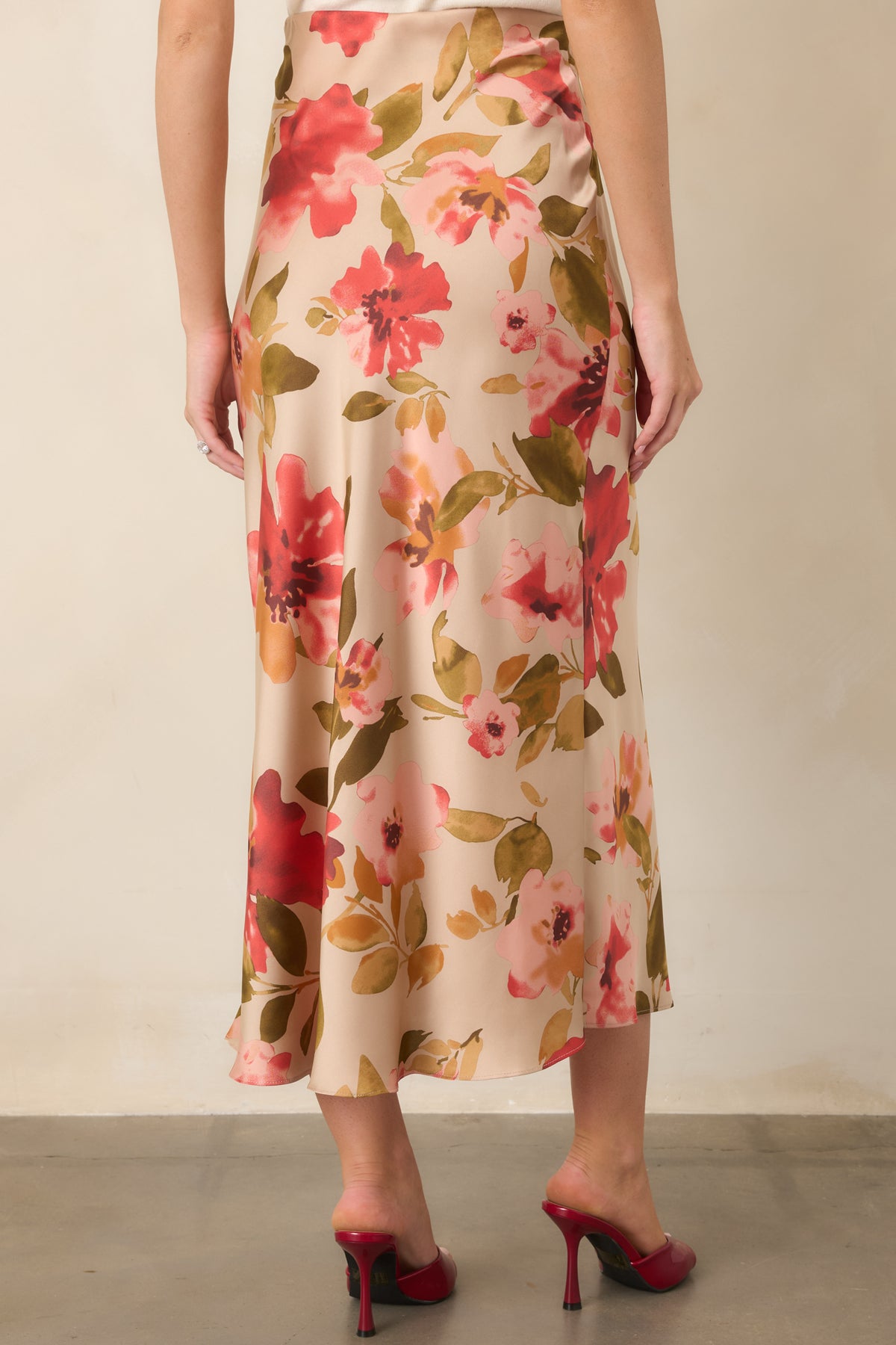 Rear of the tan floral maxi skirt showing the high-rise elastic waistband and flowing shape.