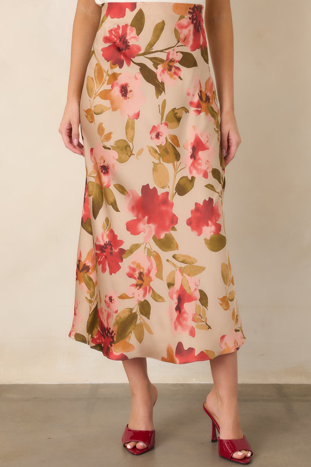High-rise tan skirt highlighting the elastic waistband and colorful watercolor-inspired floral design.