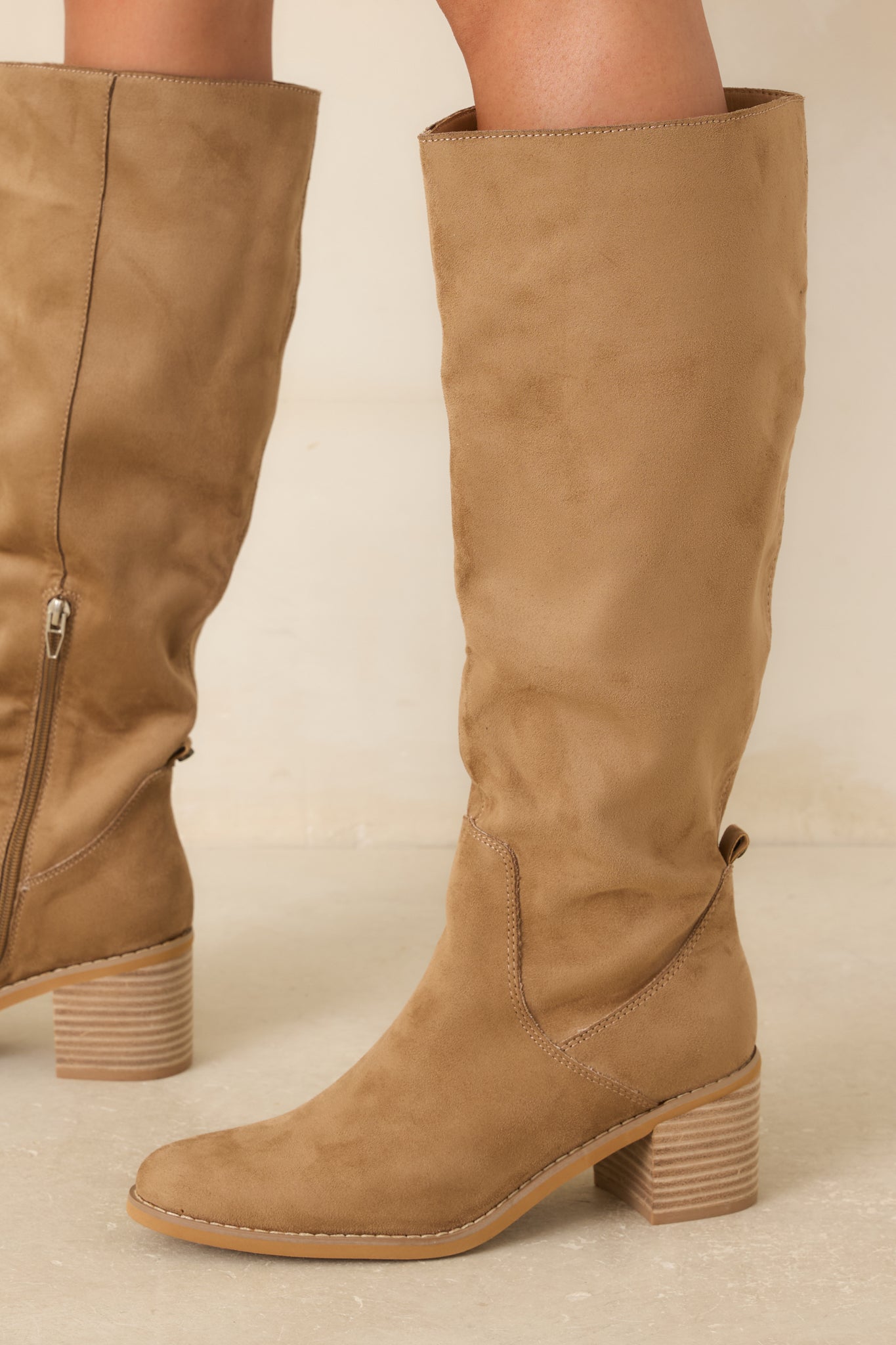 Tan knee-high boots featuring a soft faux suede finish, almond toe, and stacked block heel.