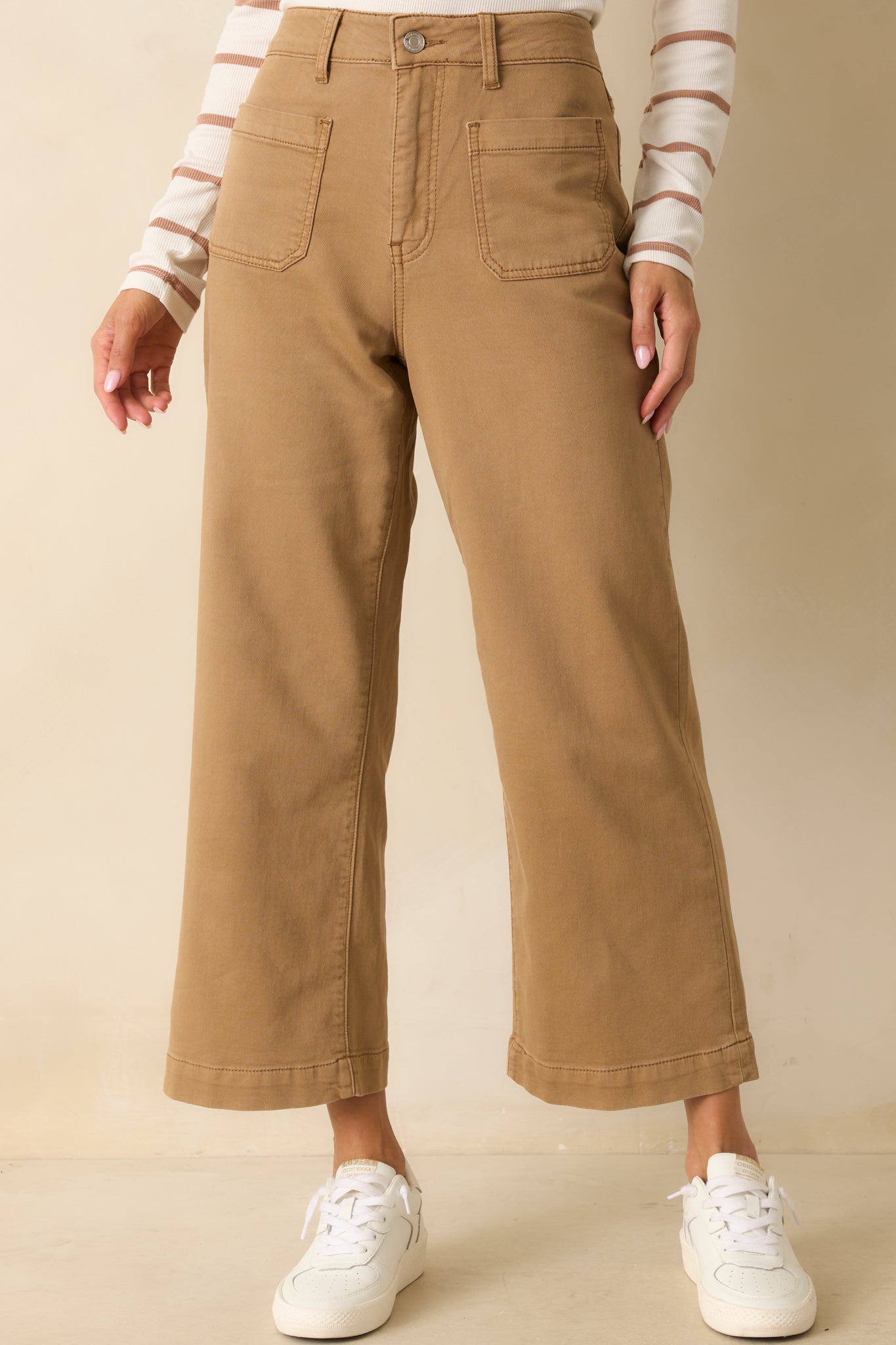 Midsection crop showing functional front pockets and high-rise waistband.