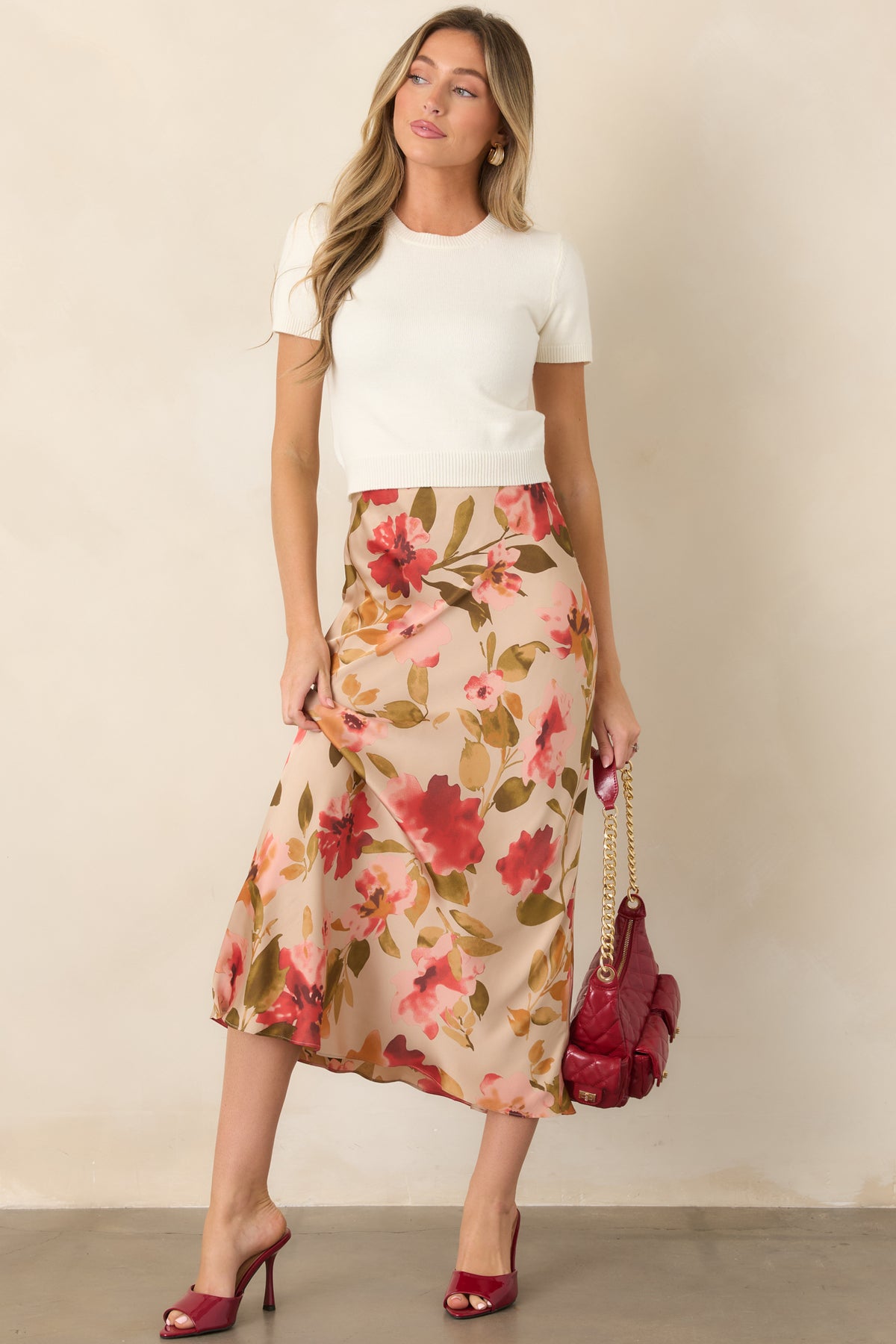 Flowing tan maxi skirt showcasing a soft pink multicolor floral pattern and high-rise waist.