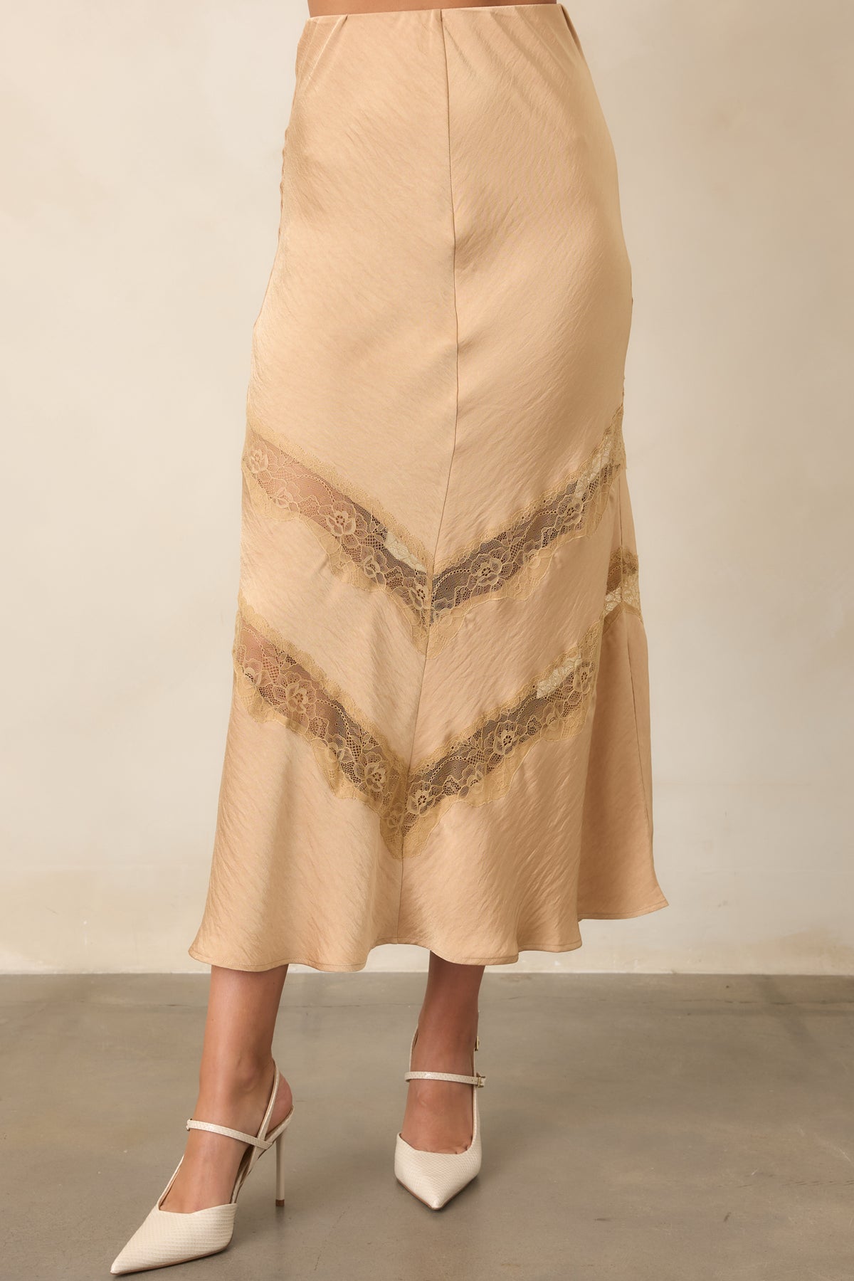 Tan skirt highlighting the delicate lace insets and softly textured fabric through the lower silhouette.