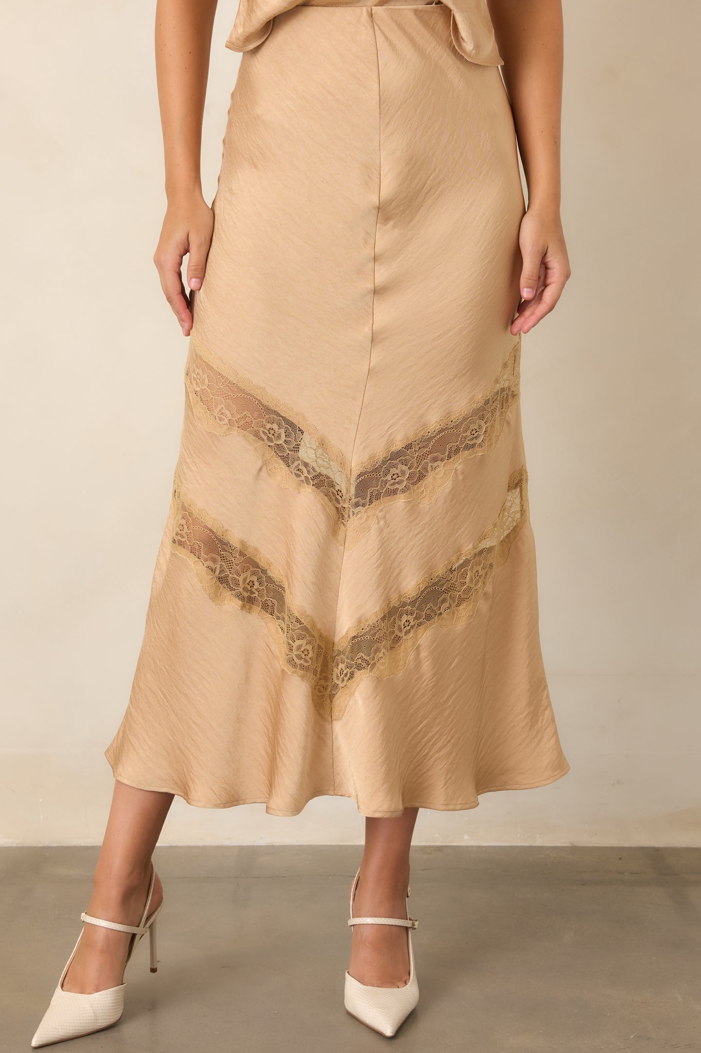 Tan skirt displaying tonal lace insets arranged in angled chevron patterns across the lower skirt.