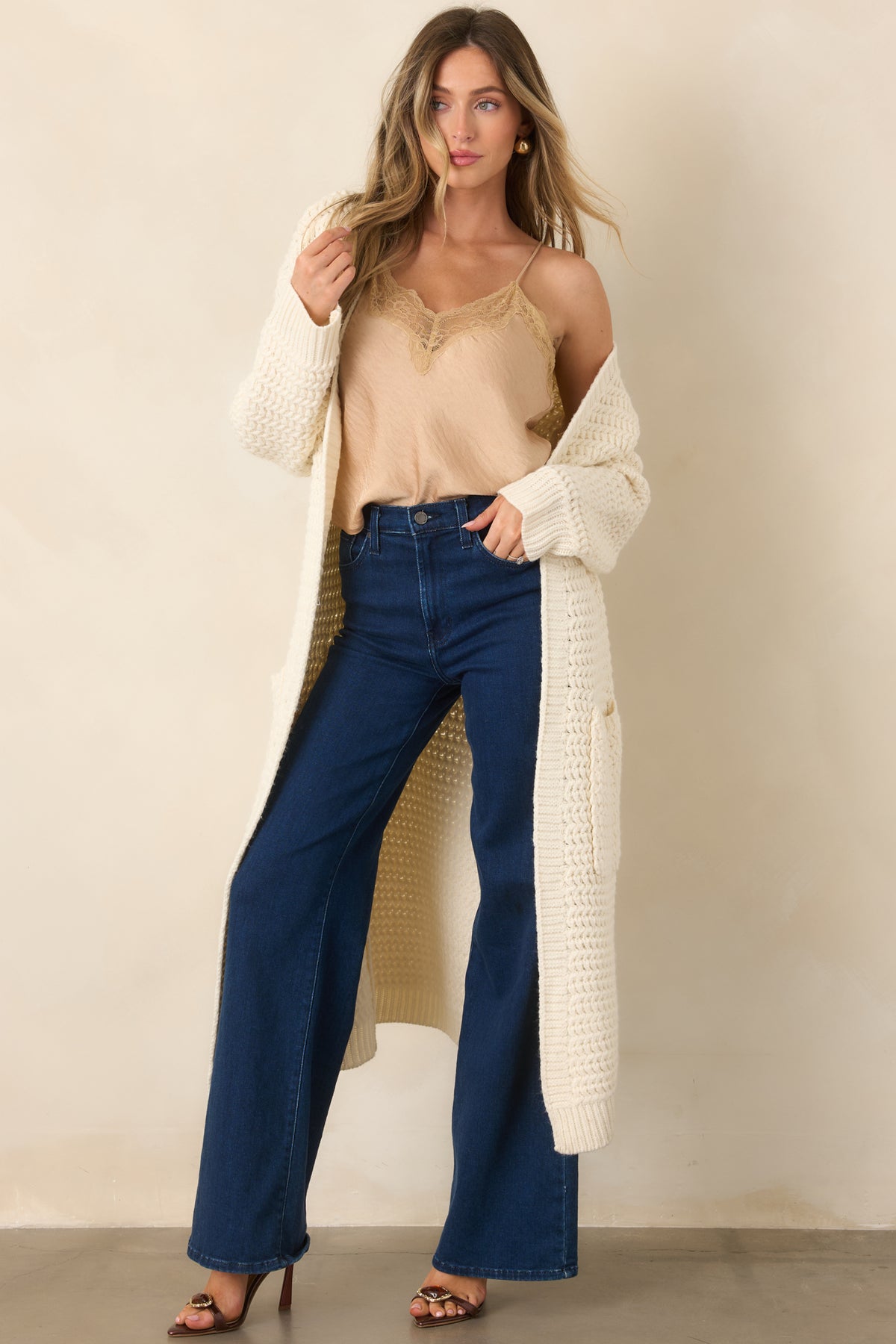 Tan sleeveless top featuring a relaxed slightly cropped shape, adjustable straps, and lace-trimmed neckline.