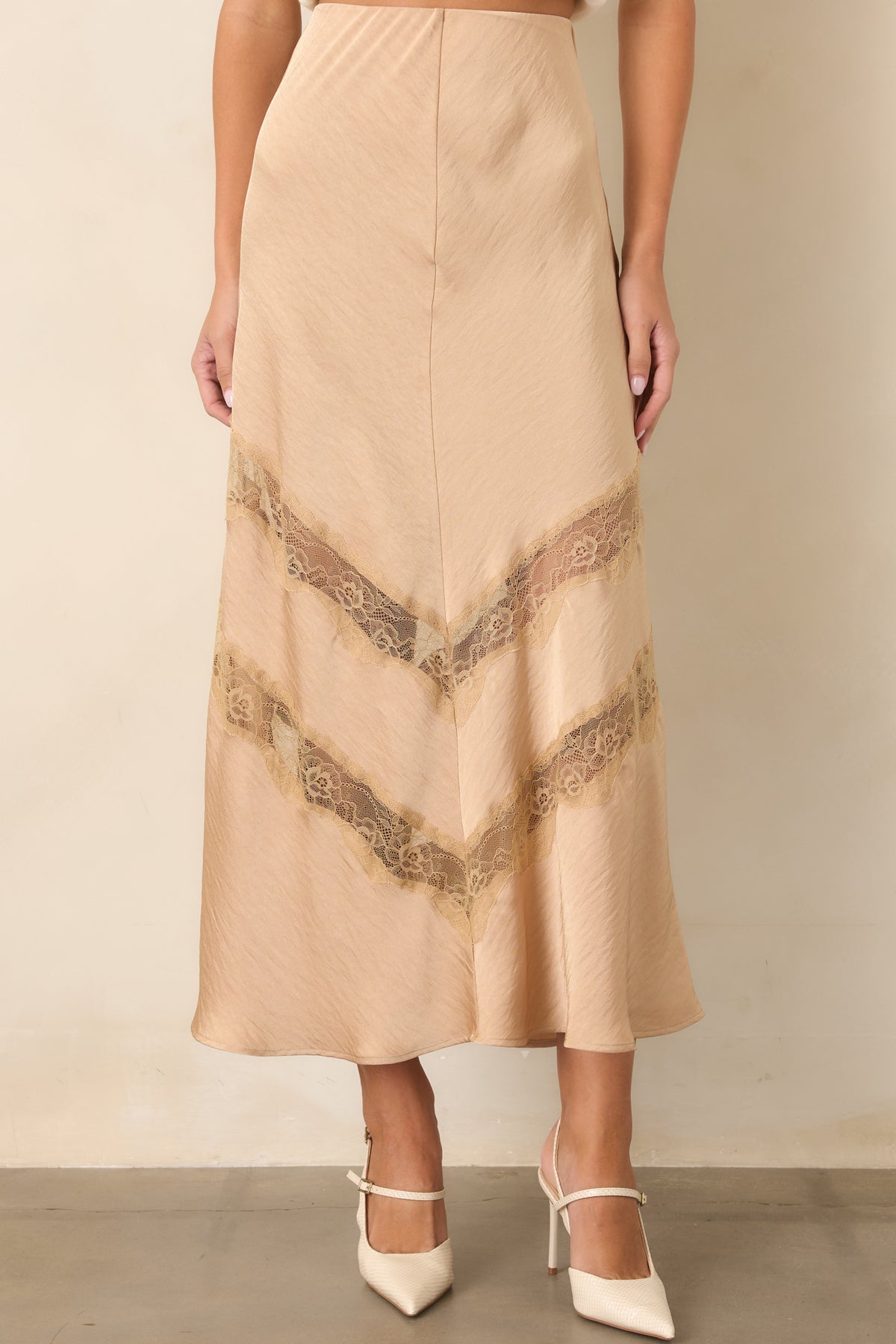 Tan skirt highlighting the smooth fitted waist and easy drape through the body.