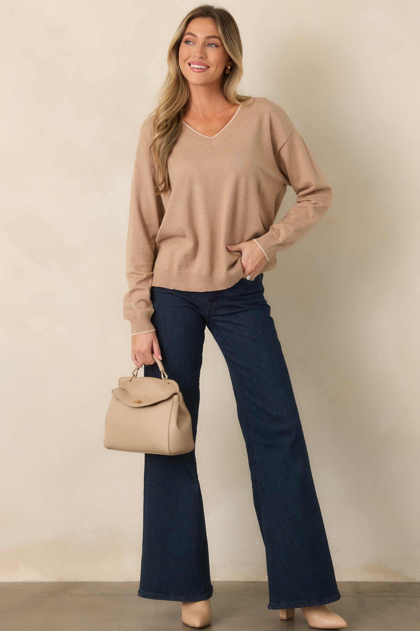 Relaxed tan top showcasing ribbed neckline, cuffs, and hem with understated contrast detailing.