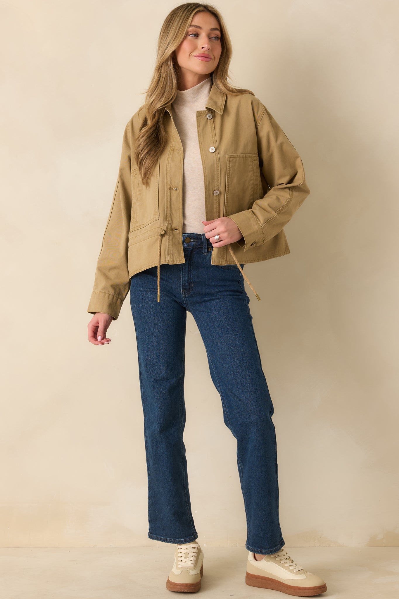 Tan utility jacket showing its collared neckline and sturdy woven fabric.