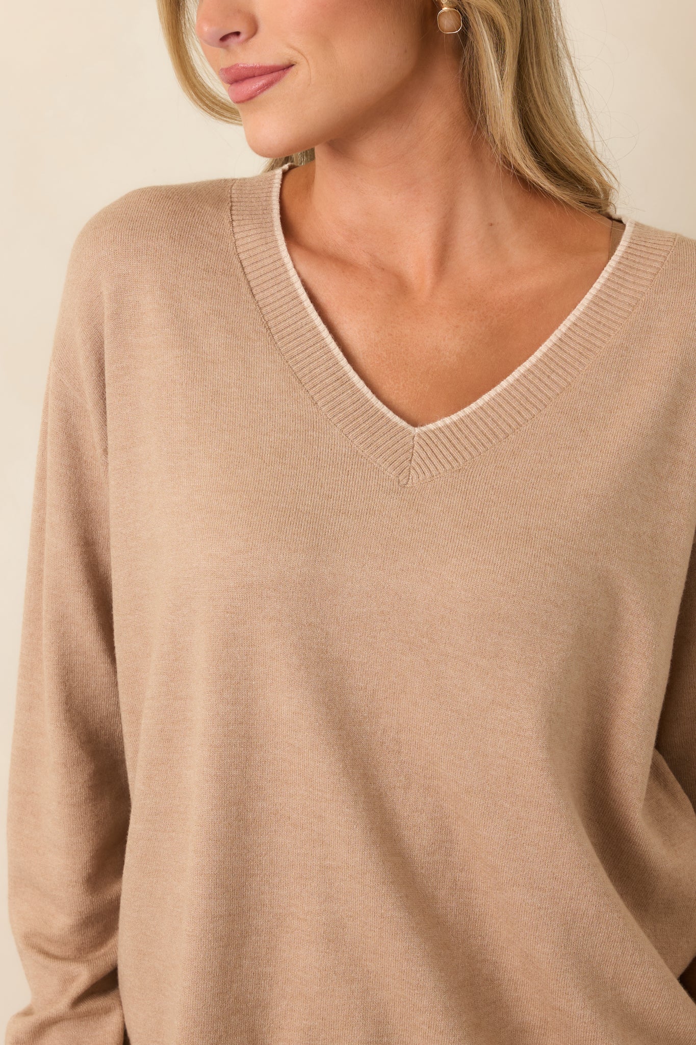 Close-up of the tan V-neckline with ribbed trim and subtle contrast edging.