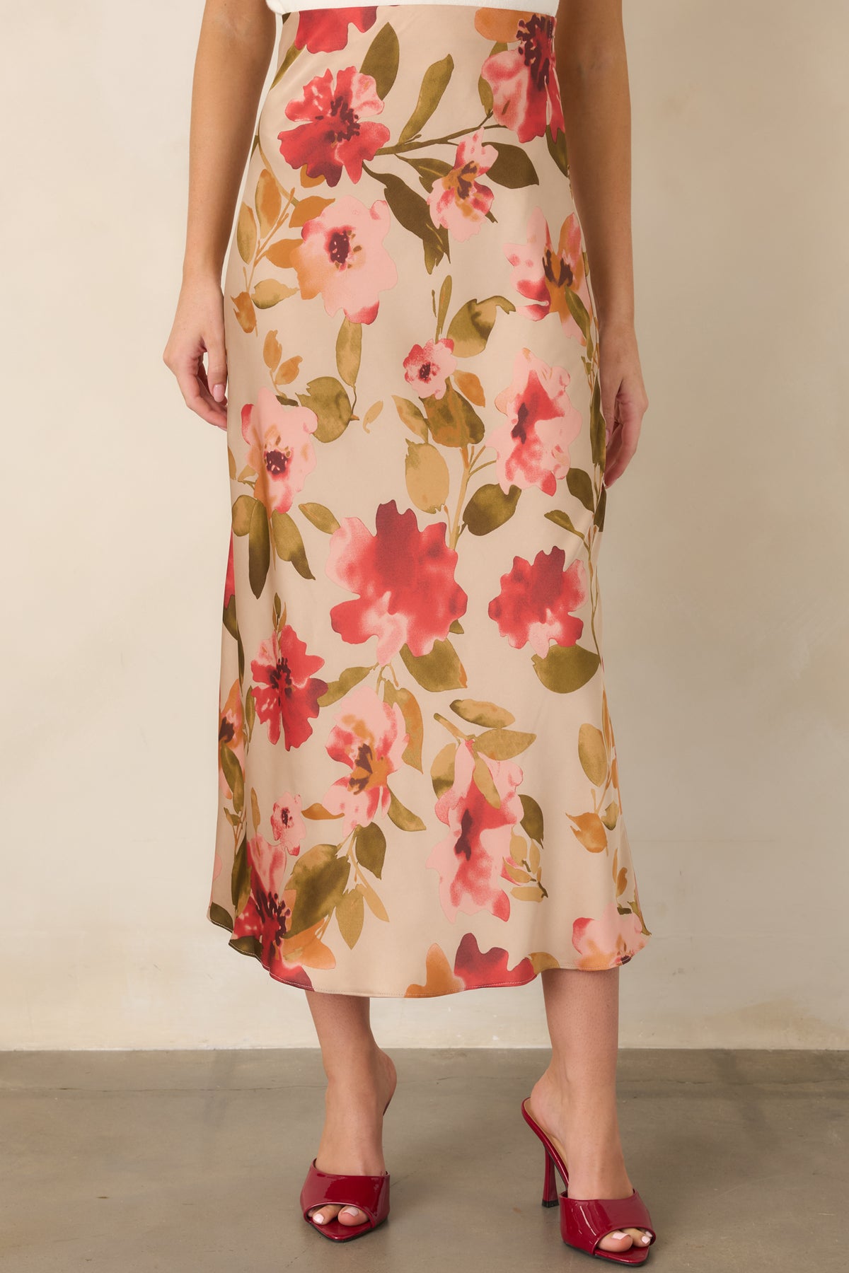 Watercolor floral print adds soft pink and multicolor accents to the tan maxi skirt.