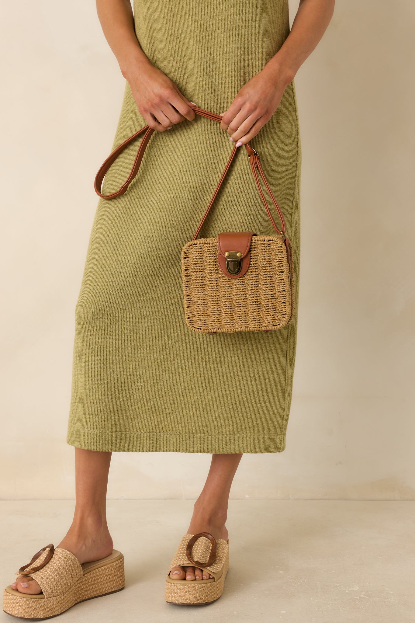 Structured wicker handbag showcasing a woven tan body, brown faux leather details, and spacious lined interior.