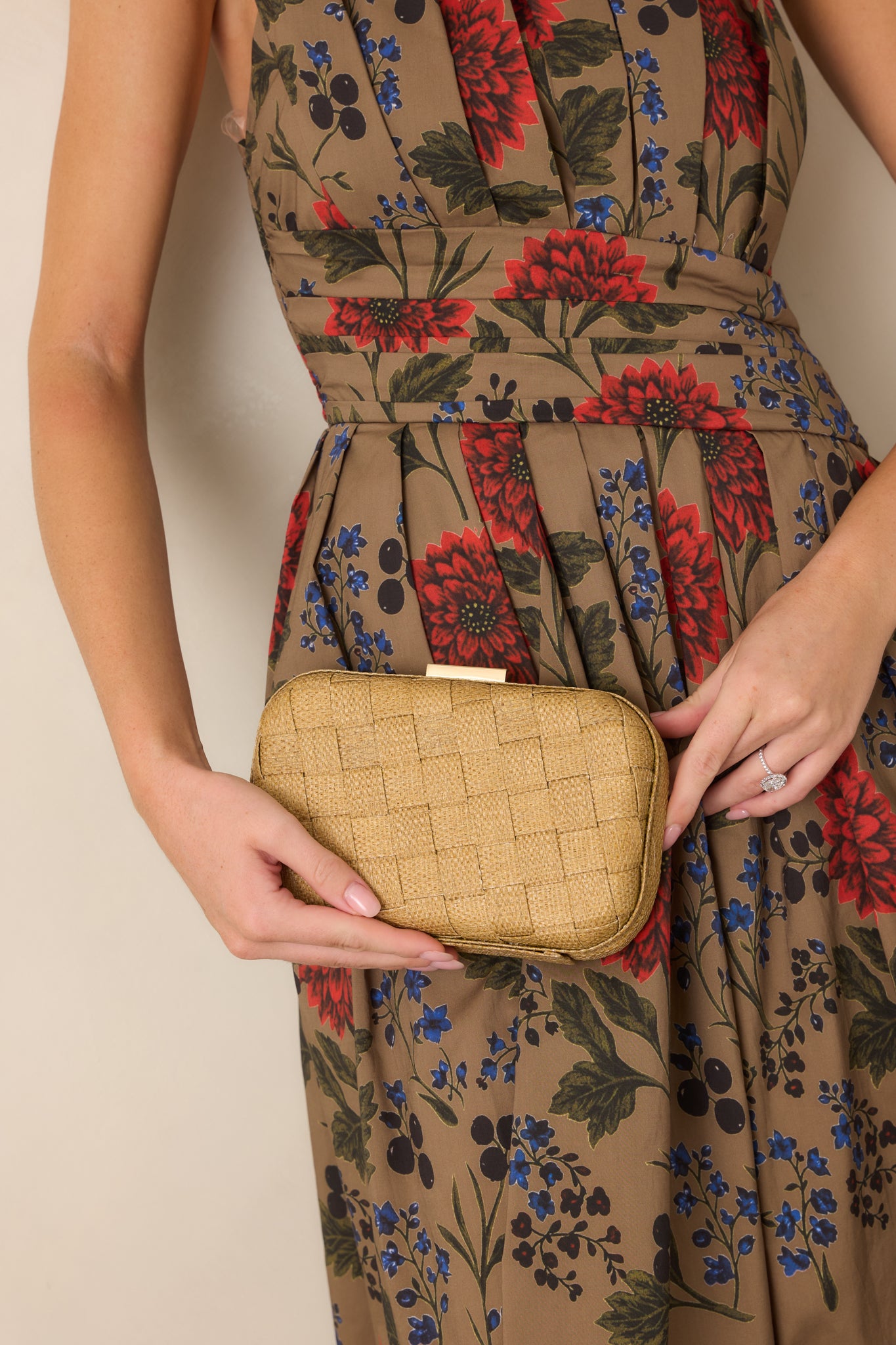 Tan woven clutch featuring a sleek structured shape and polished gold-tone clasp for an elegant finishing touch.