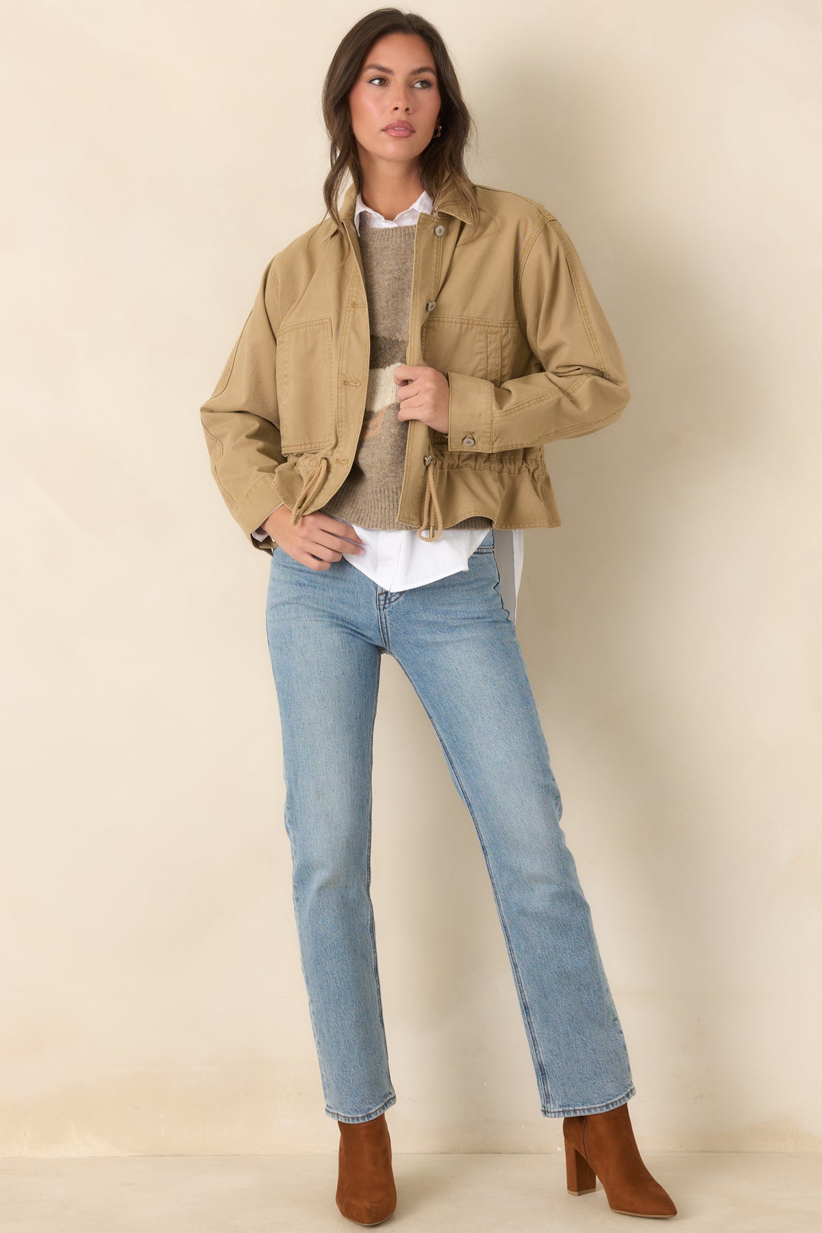 Relaxed tan woven jacket showcases a classic collar, long sleeves, and a drawcord-adjustable hem.