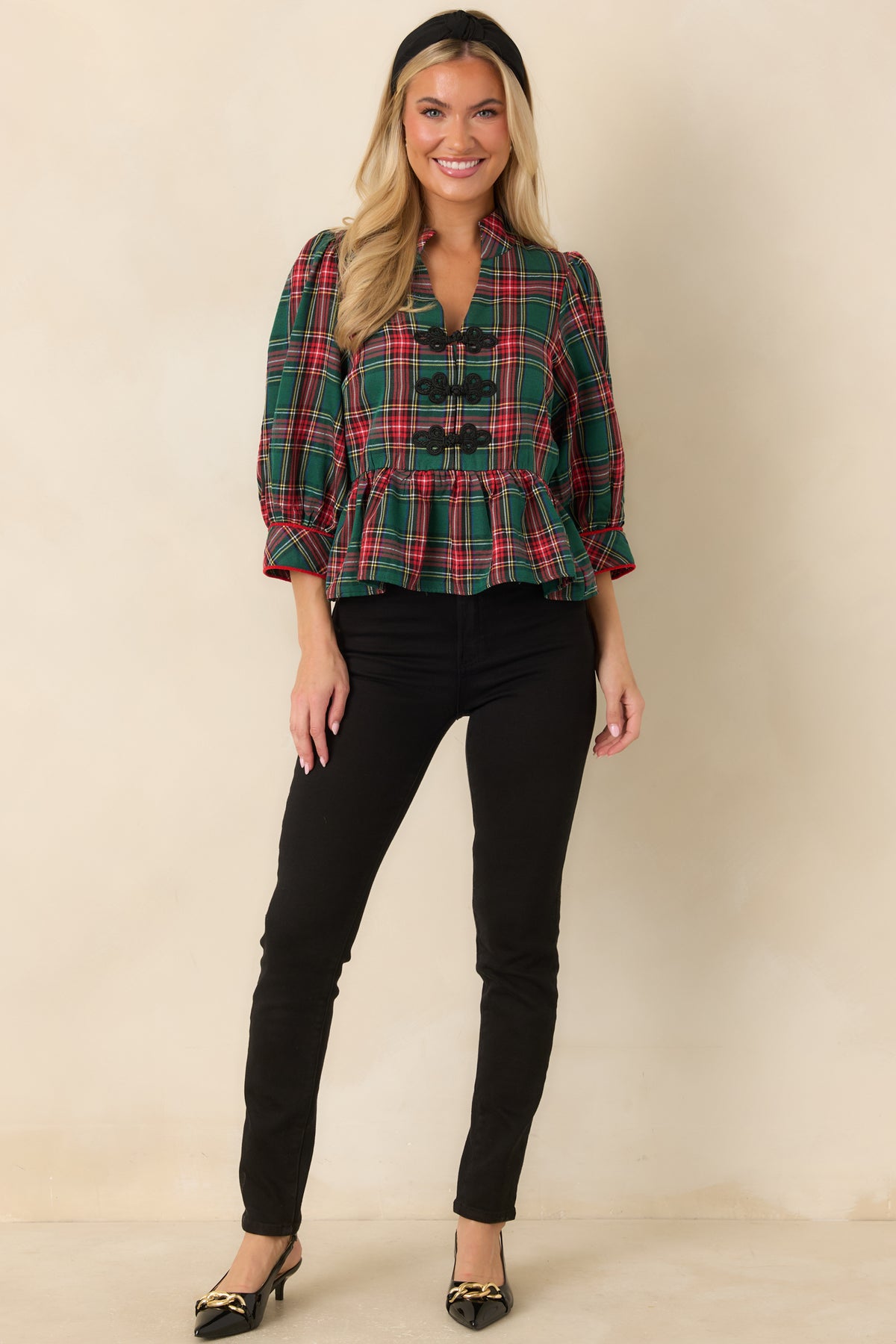 Tartan plaid blouse featuring three-quarter puff sleeves, red piping, and a split neckline.