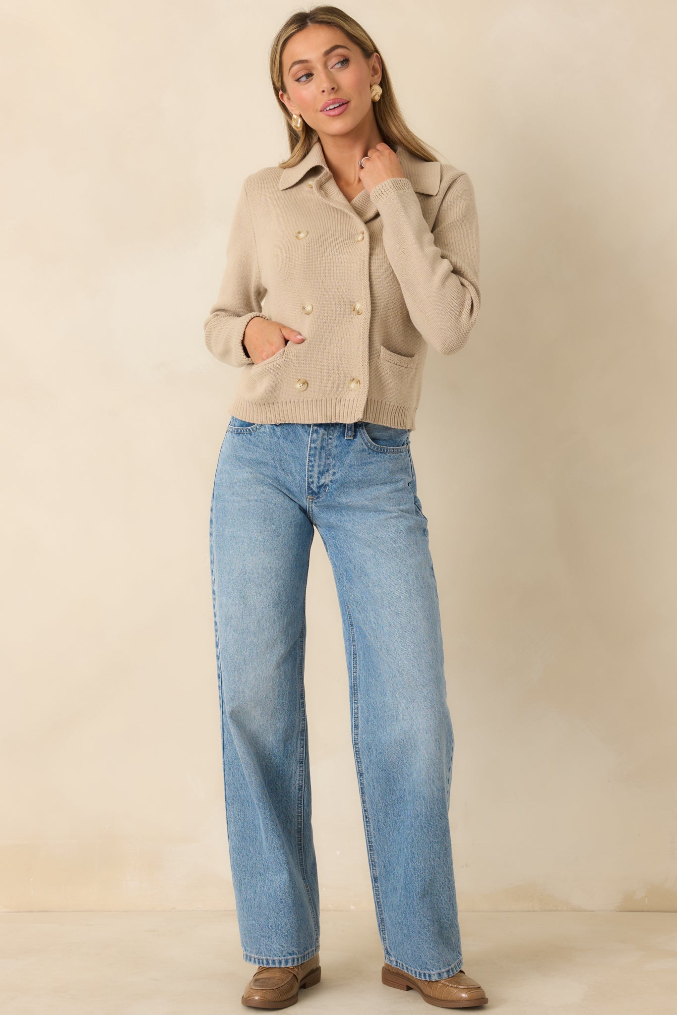 Taupe knit cardigan highlighting the collared neckline, long sleeves, and clean proportions with subtle structure.