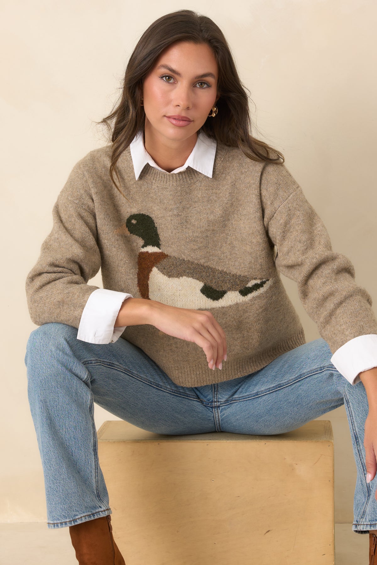 Classic crew neckline and ribbed trim frame the mallard design on this taupe knit sweater.