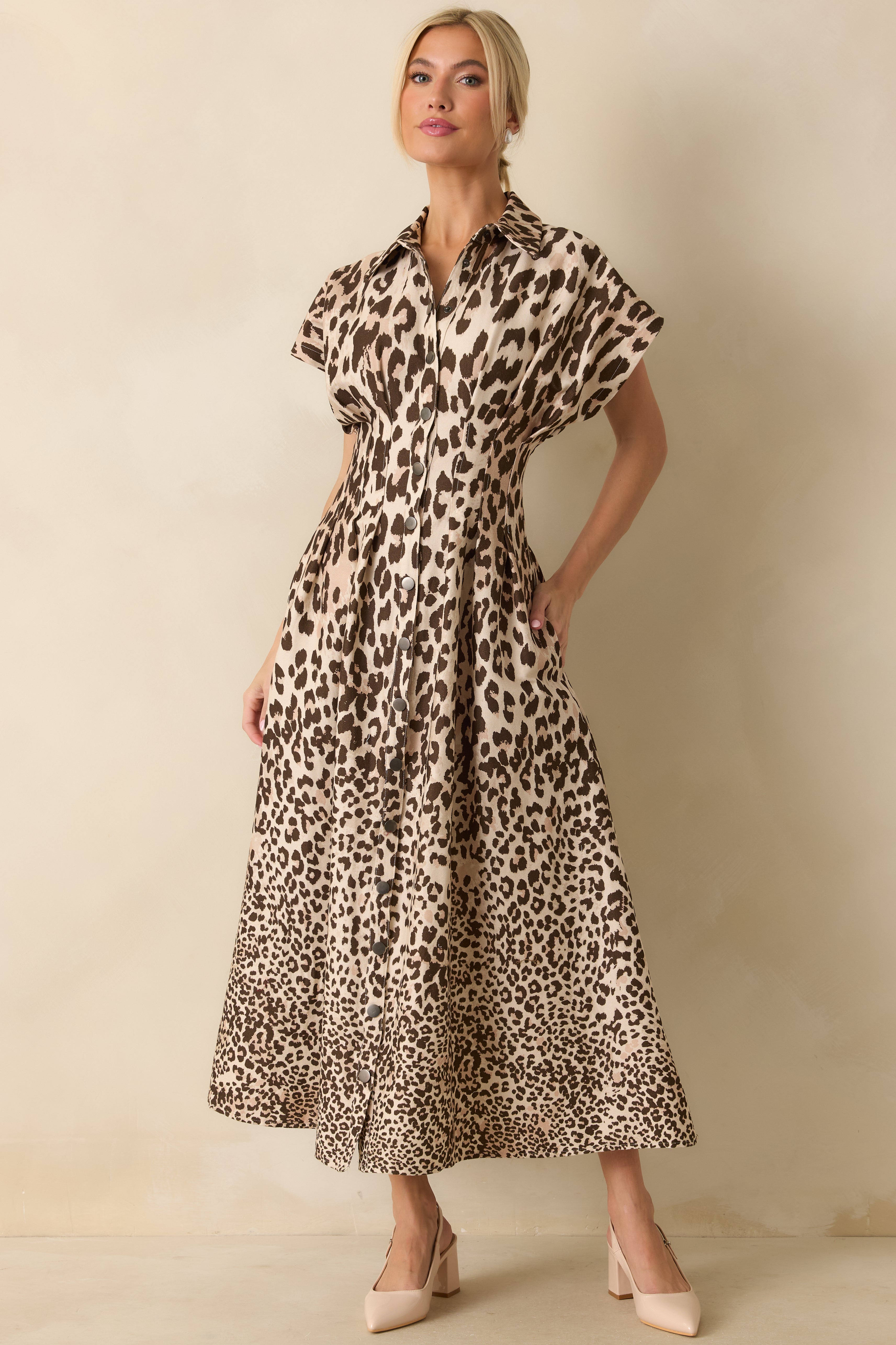 Front view of the taupe leopard print maxi dress with short sleeves, collared neckline, and front snap-button closure highlighting the structured cotton twill fabric.