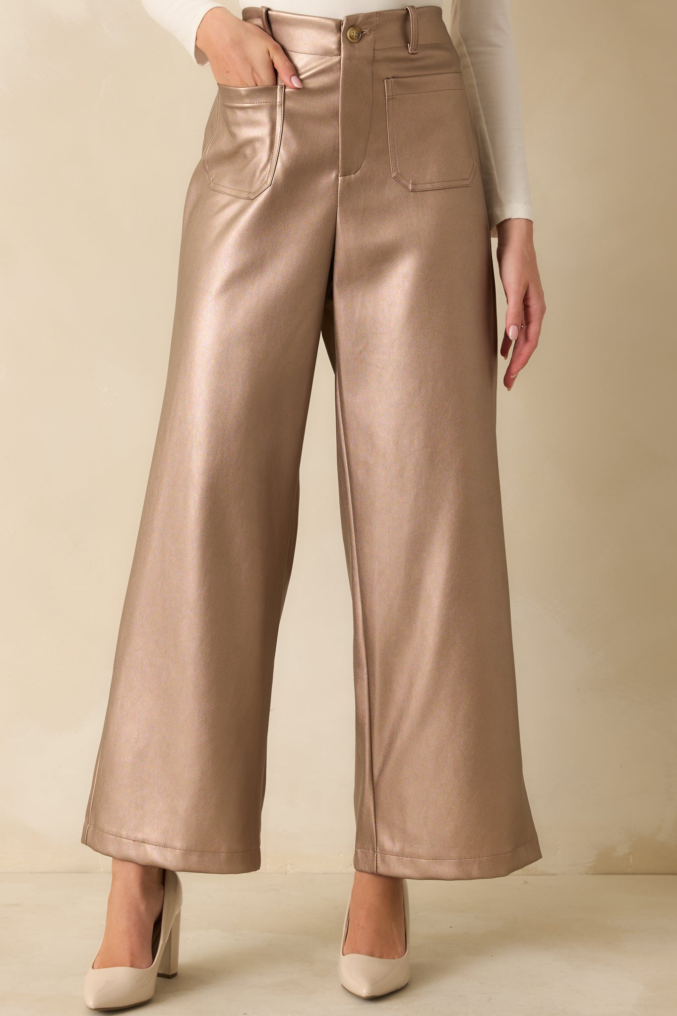 Front patch pockets and button zip fly closure highlighted on the lustrous taupe material.