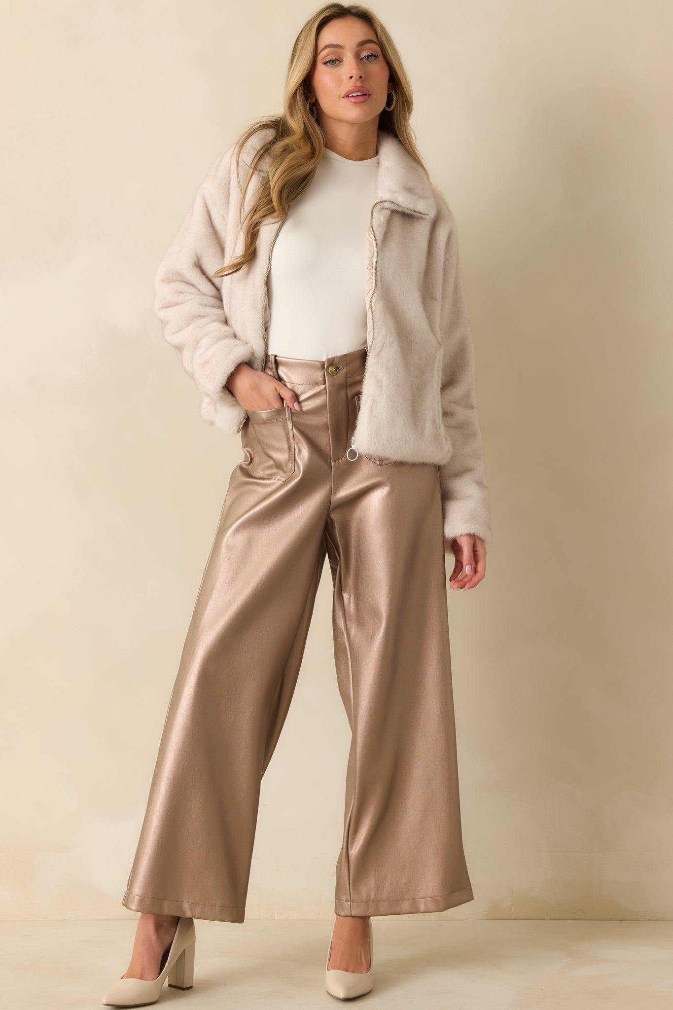 Shimmering taupe metallic pants styled with front patch pockets and a structured wide leg shape.