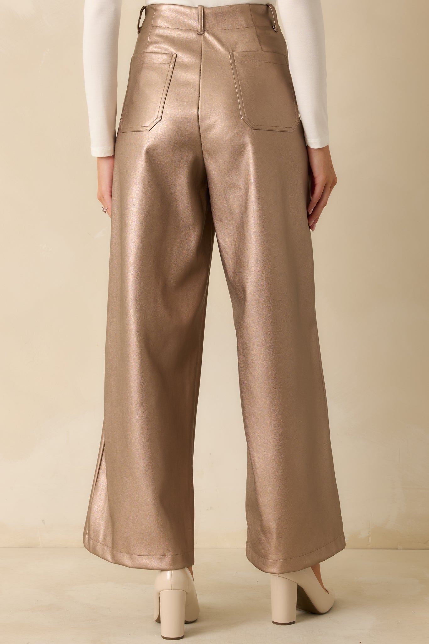 Rear view of the taupe metallic pants featuring a smooth, structured fit and wide leg drape.