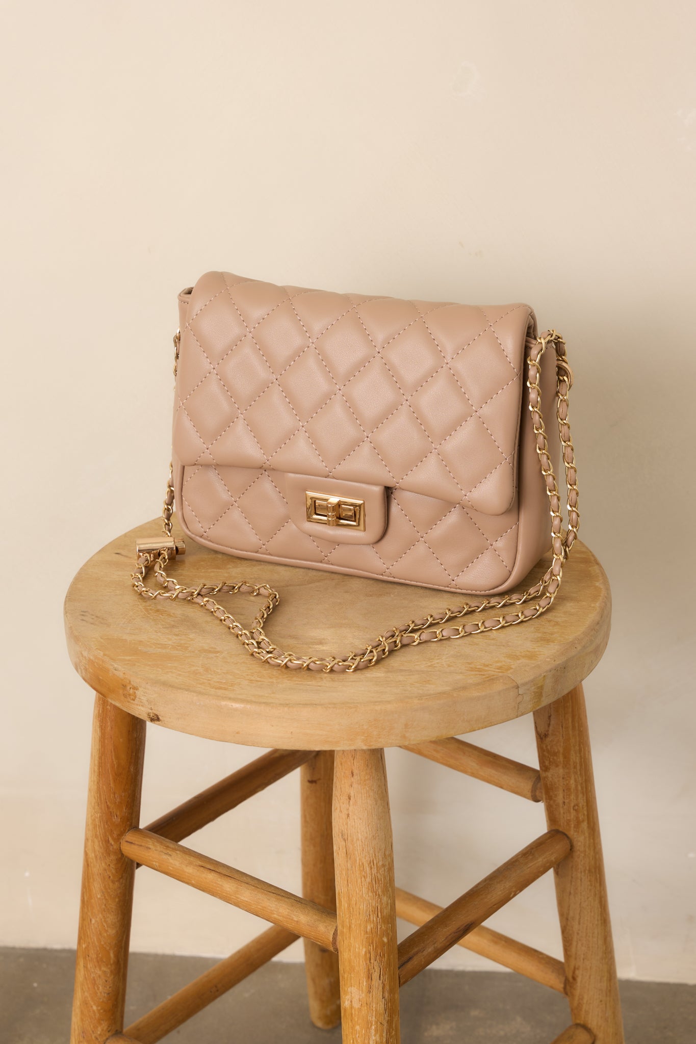 Taupe handbag showcasing the dimensional quilted pattern, structured edges, and smooth chain strap for a polished finish.