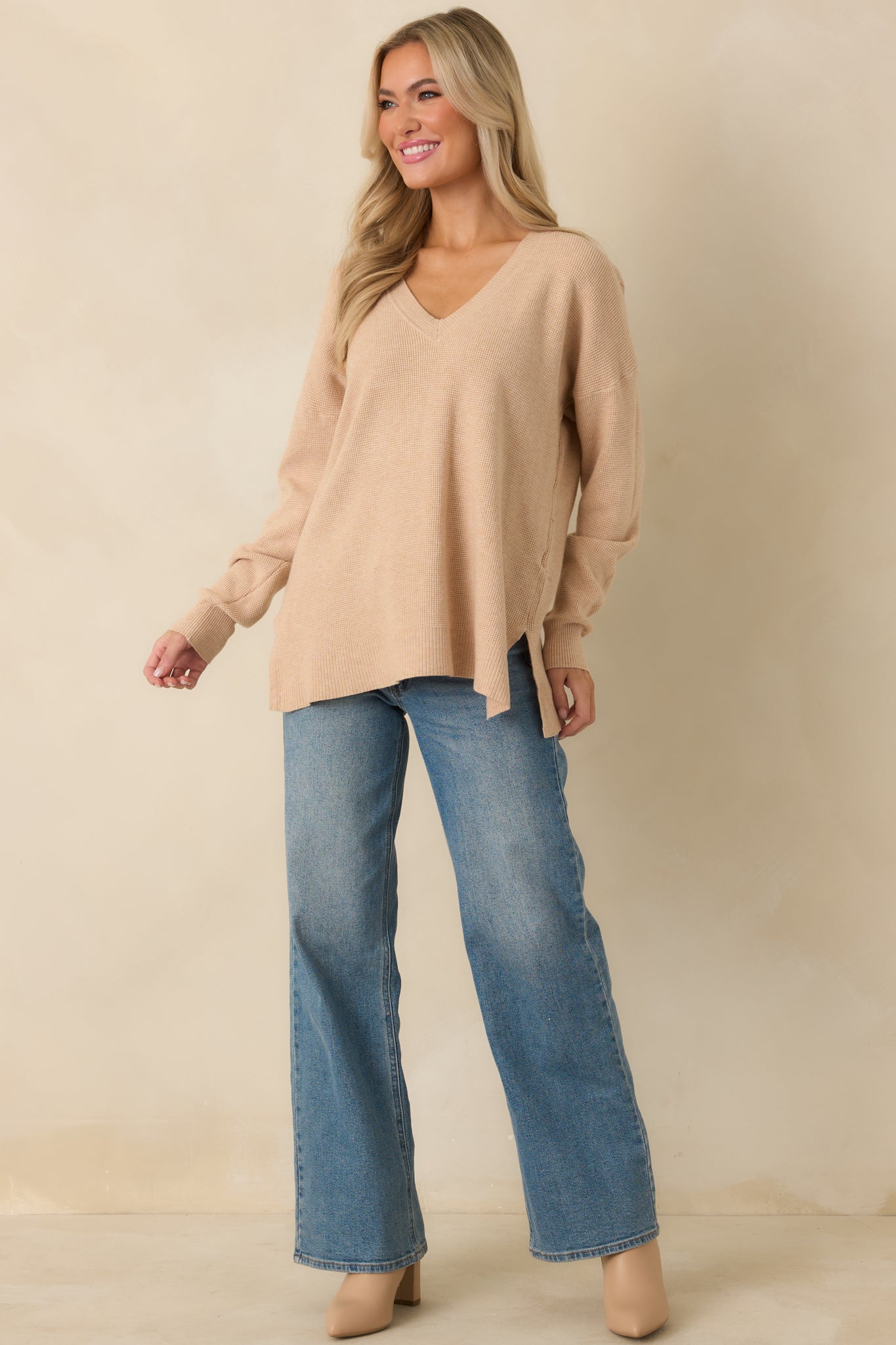 Taupe V-neck sweater in soft fabric with long ribbed sleeves and relaxed, comfortable fit.