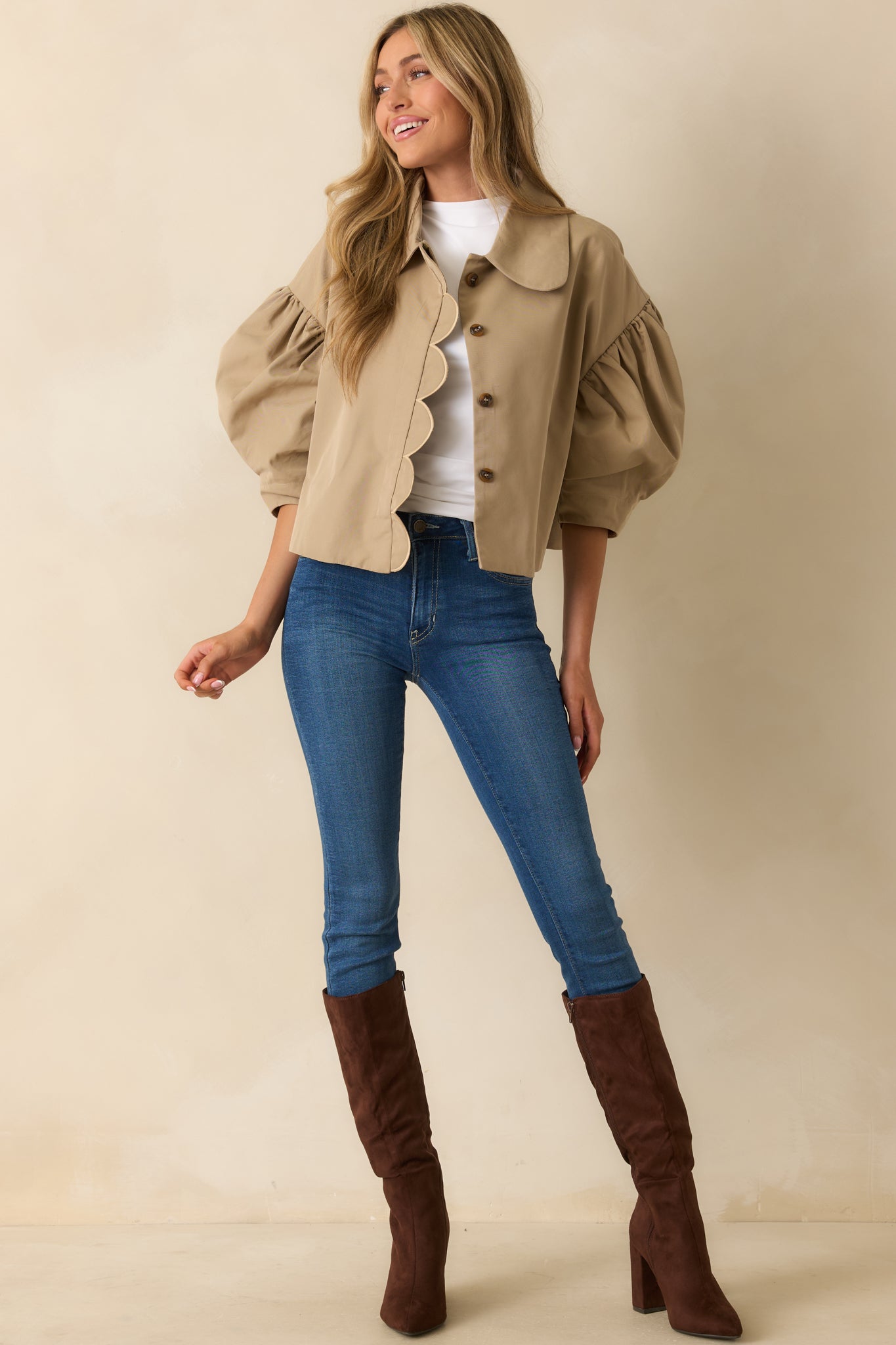 Full view of taupe woven jacket showcasing puffed sleeves, scalloped button-front placket, and cropped silhouette.