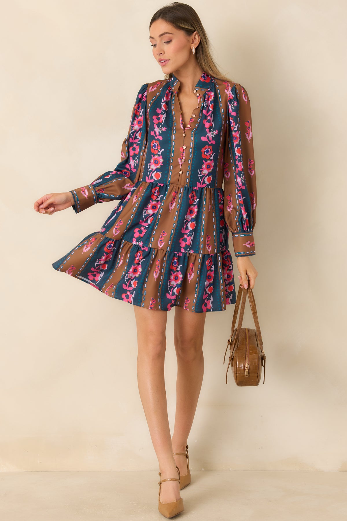 Teal and caramel striped mini dress with pink, coral, and ivory florals, a stand collar, and a flowing tiered skirt.