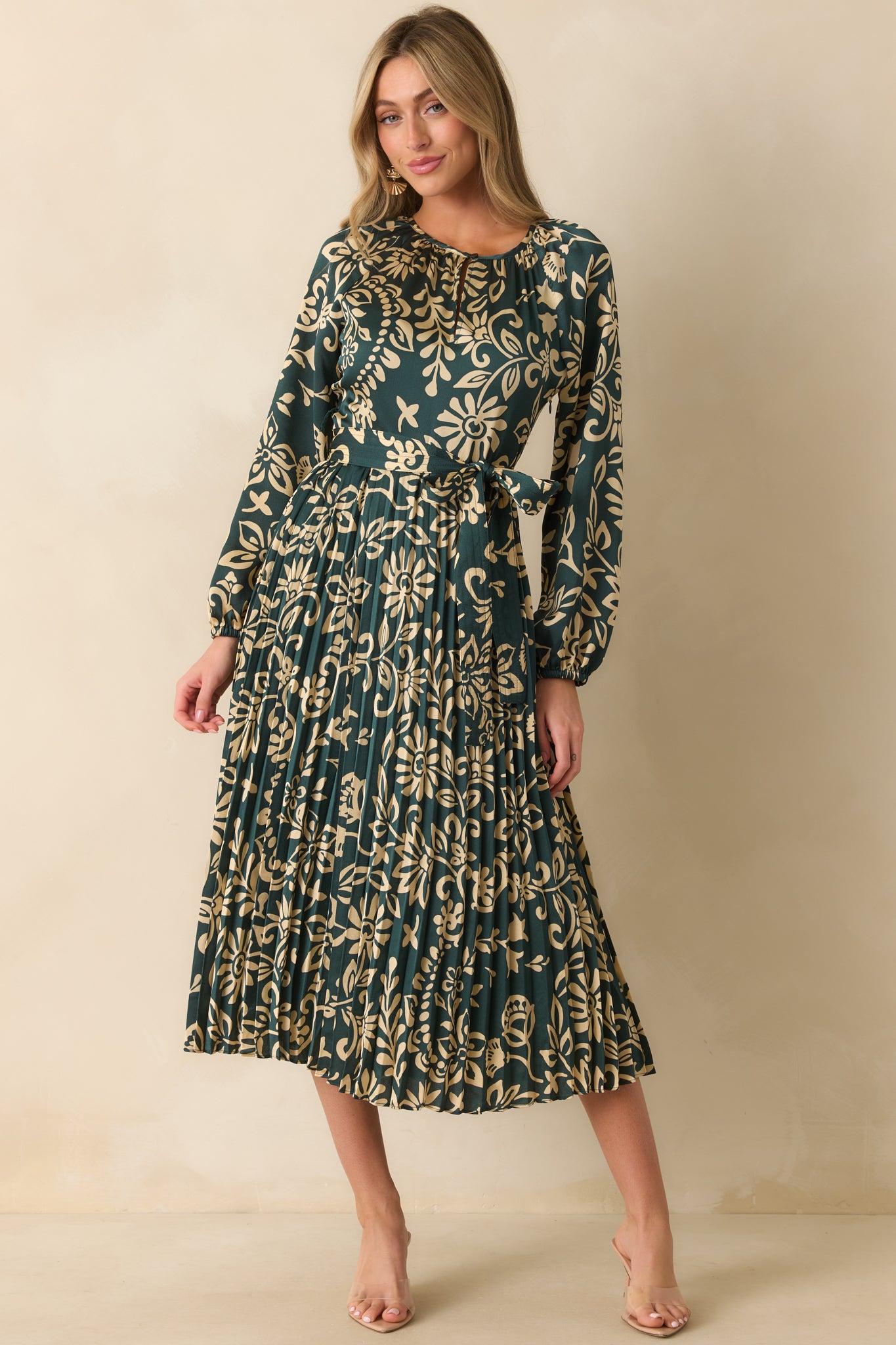 Teal floral dress featuring a full-length green lining beneath the pleated skirt.
